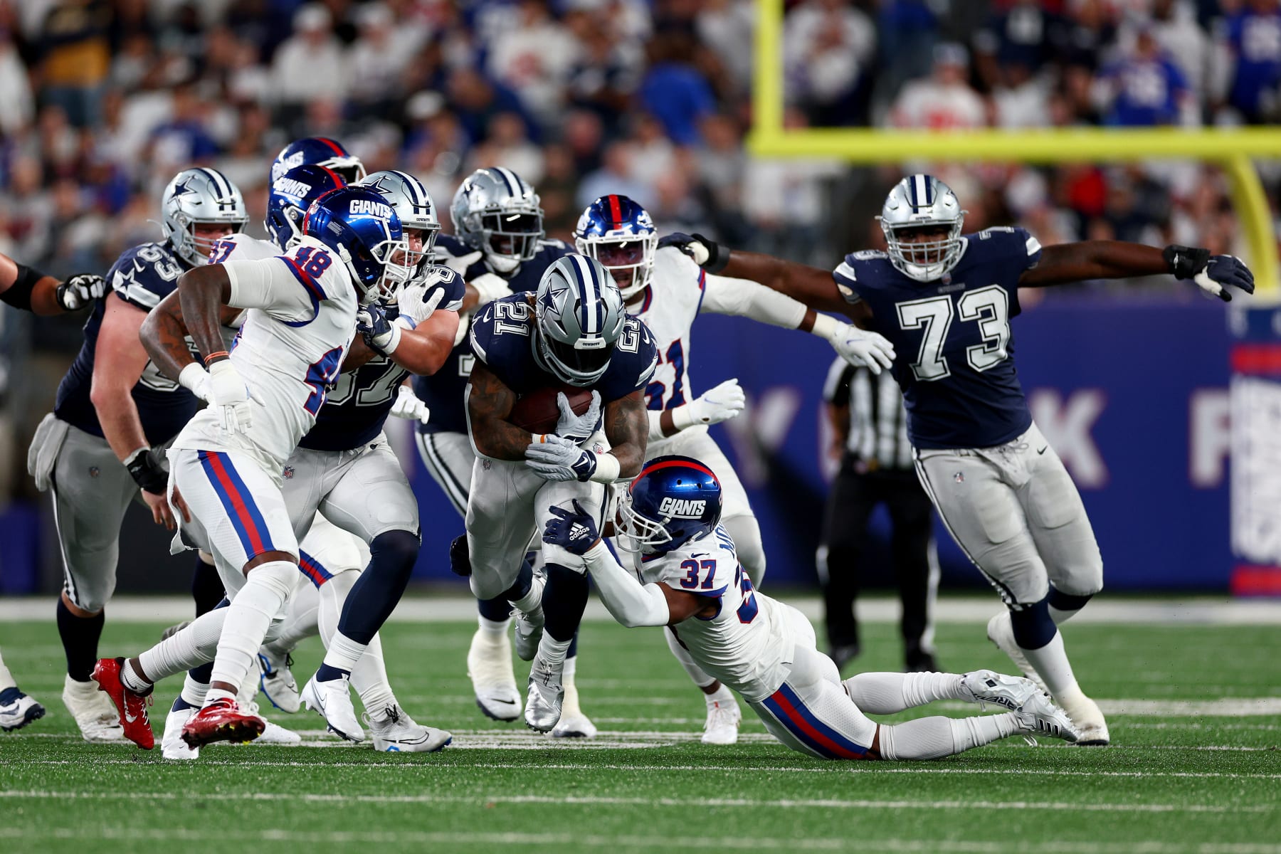 Dallas Cowboys running back Ezekiel Elliott (21) carries the ball during  the first half of an NFL football game against the Washington Commanders,  Sunday, Oct. 2, 2022, in Arlington, Texas. Dallas won