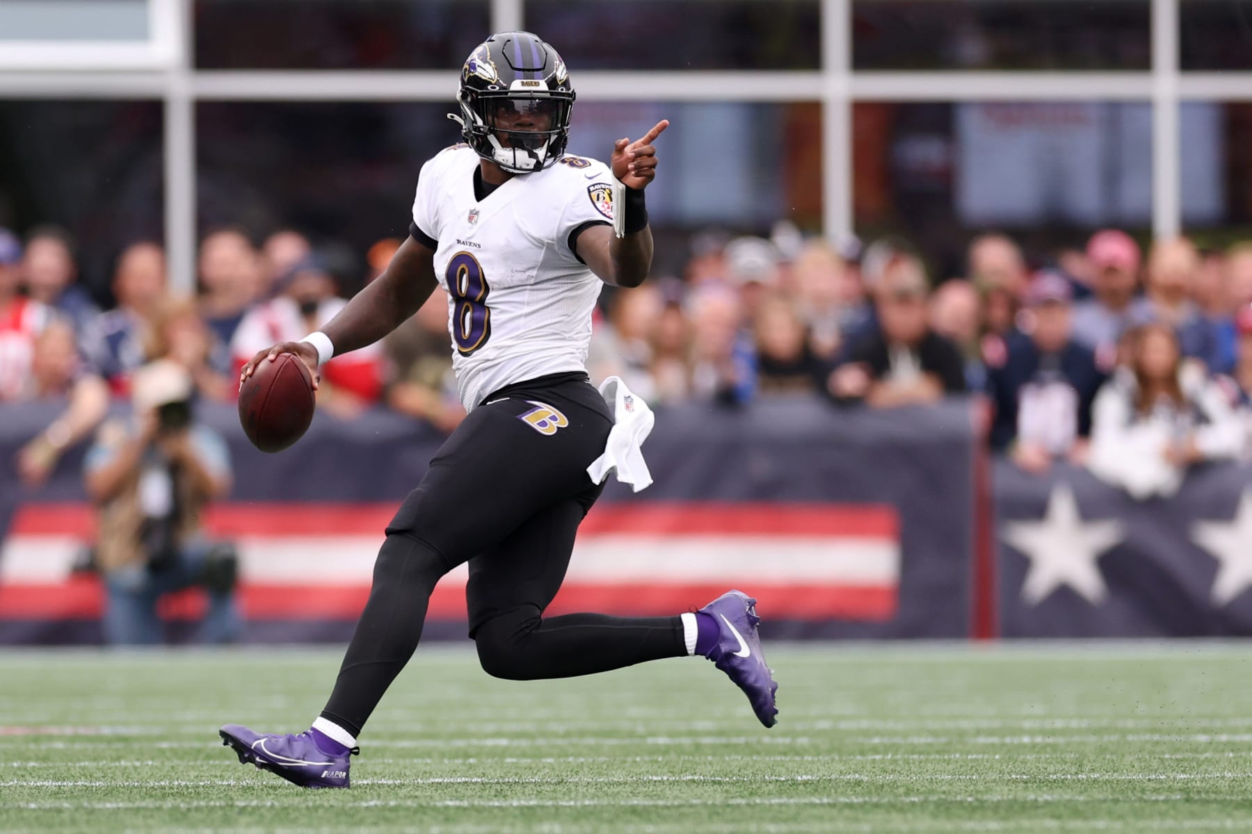 FOXBOROUGH, MASSACHUSETTS - SEPTEMBER 25: Lamar Jackson #8 of the Baltimore Ravens carries the ball against the New England Patriots  at Gillette Stadium on September 25, 2022 in Foxborough, Massachusetts. (Photo by Maddie Meyer/Getty Images)