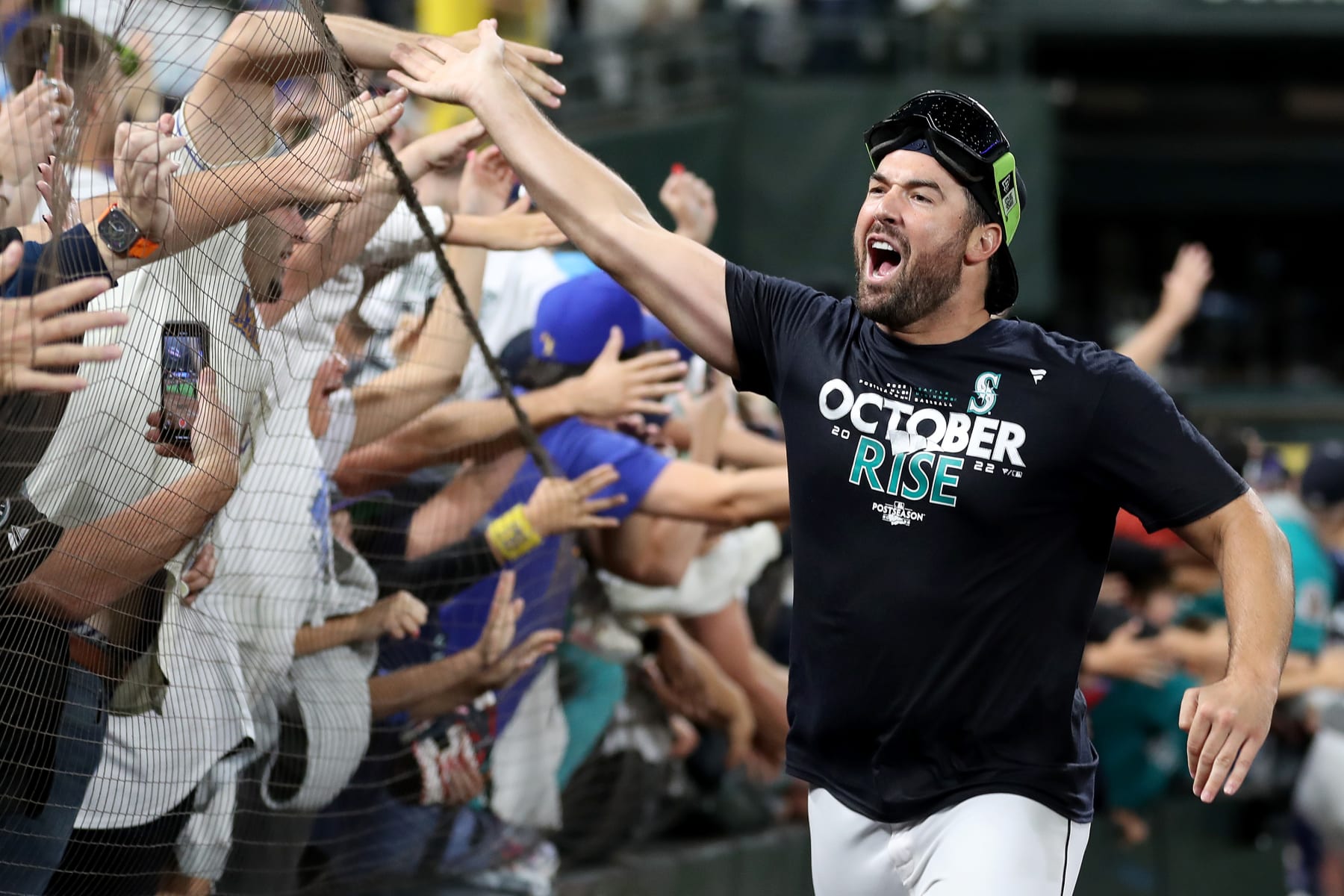 SEATTLE, WASHINGTON - SEPTEMBER 30: Robbie Ray #38 of the Seattle Mariners celebrates with fans after clinching a postseason birth after beating the Oakland Athletics 2-1 at T-Mobile Park on September 30, 2022 in Seattle, Washington. The Seattle Mariners have clinched a postseason appearance for the first time in 21 years, the longest playoff drought in North American professional sports. (Photo by Steph Chambers/Getty Images)