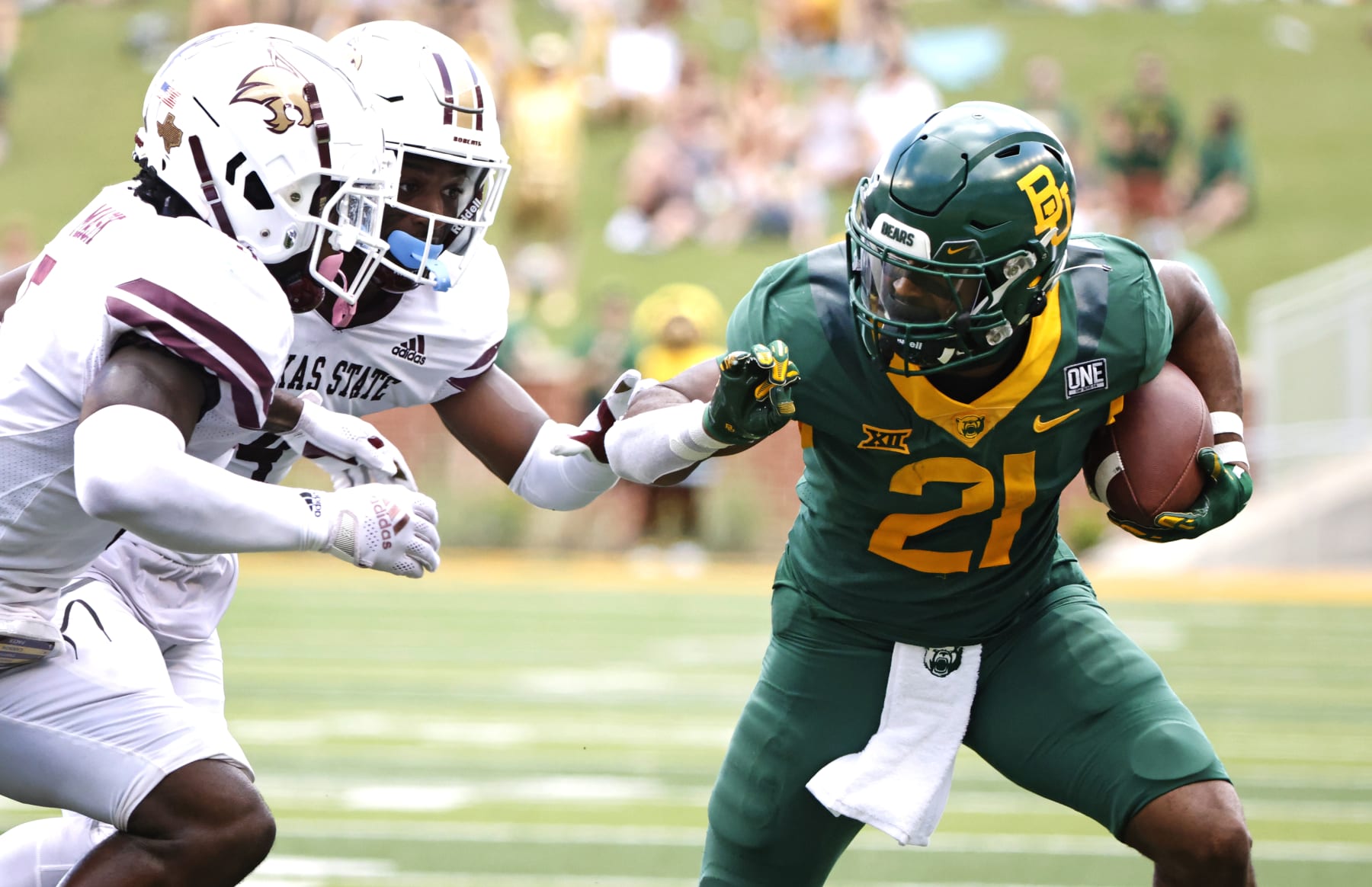 WACO, TX - SEPTEMBER 17: Josh Fleeks #21 of the Baylor Bears tries to elude DeJordan Mask #5 of the Texas State Bobcats and teammate Alonzo Edwards Jr. #4 in the second half at McLane Stadium on September 17, 2022 in Waco, Texas. Baylor won 42-7. (Photo by Ron Jenkins/Getty Images)