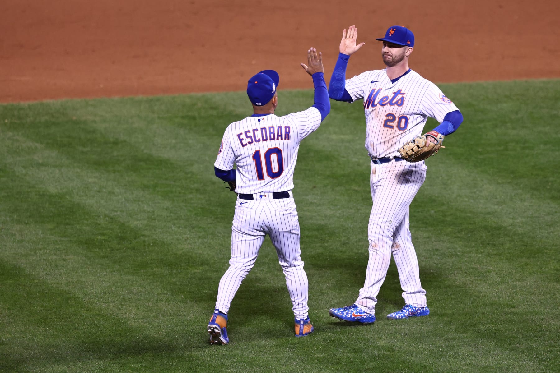 NEW YORK, NEW YORK - OCTOBER 08: Eduardo Escobar #10 of the New York Mets and Pete Alonso #20 celebrate defeating the San Diego Padres 7-3 in game two of the Wild Card Series at Citi Field on October 08, 2022 in New York City. (Photo by Dustin Satloff/Getty Images)