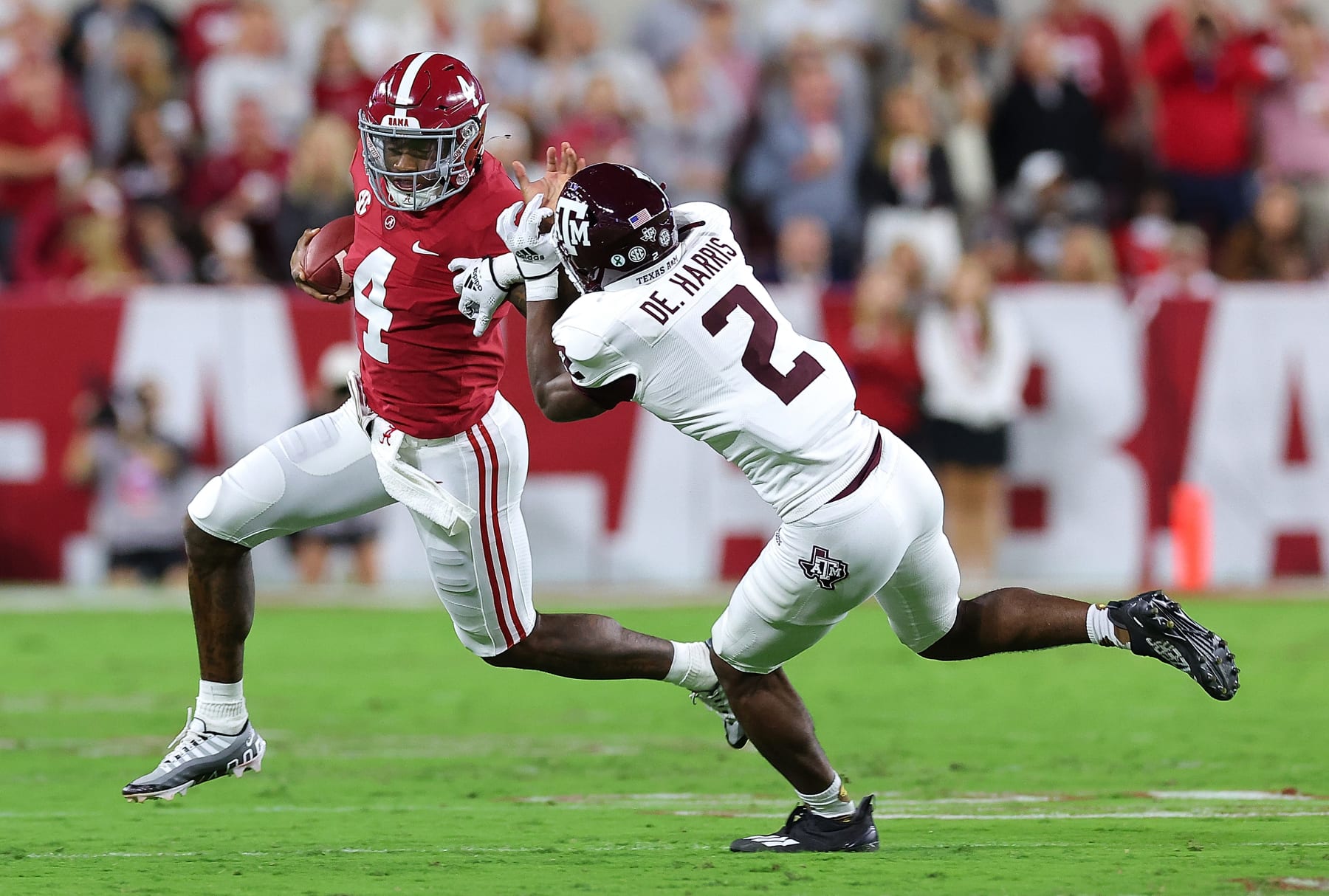 TUSCALOOSA, ALABAMA - OCTOBER 08: Jalen Milroe #4 of the Alabama Crimson Tide rushes away from Denver Harris #2 of the Texas A&M Aggies during the first half at Bryant-Denny Stadium on October 08, 2022 in Tuscaloosa, Alabama. (Photo by Kevin C. Cox/Getty Images)