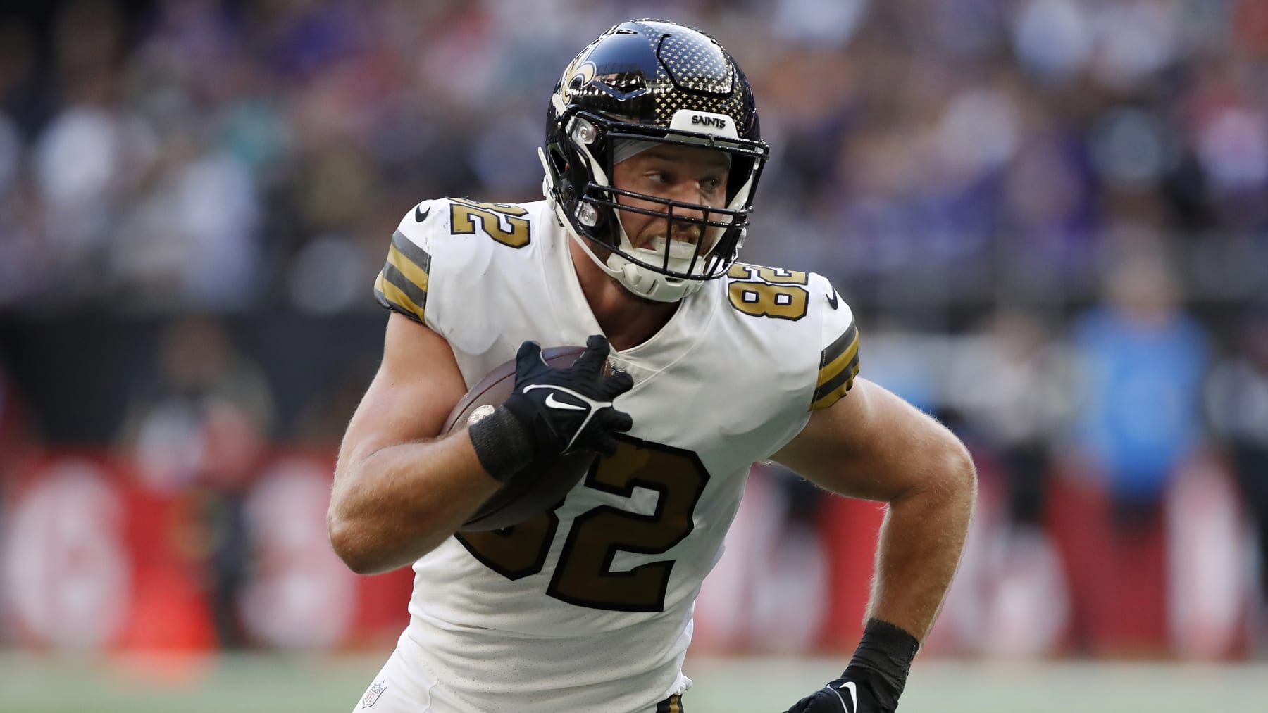 New Orleans Saints tight end Adam Trautman (82) runs the ball up