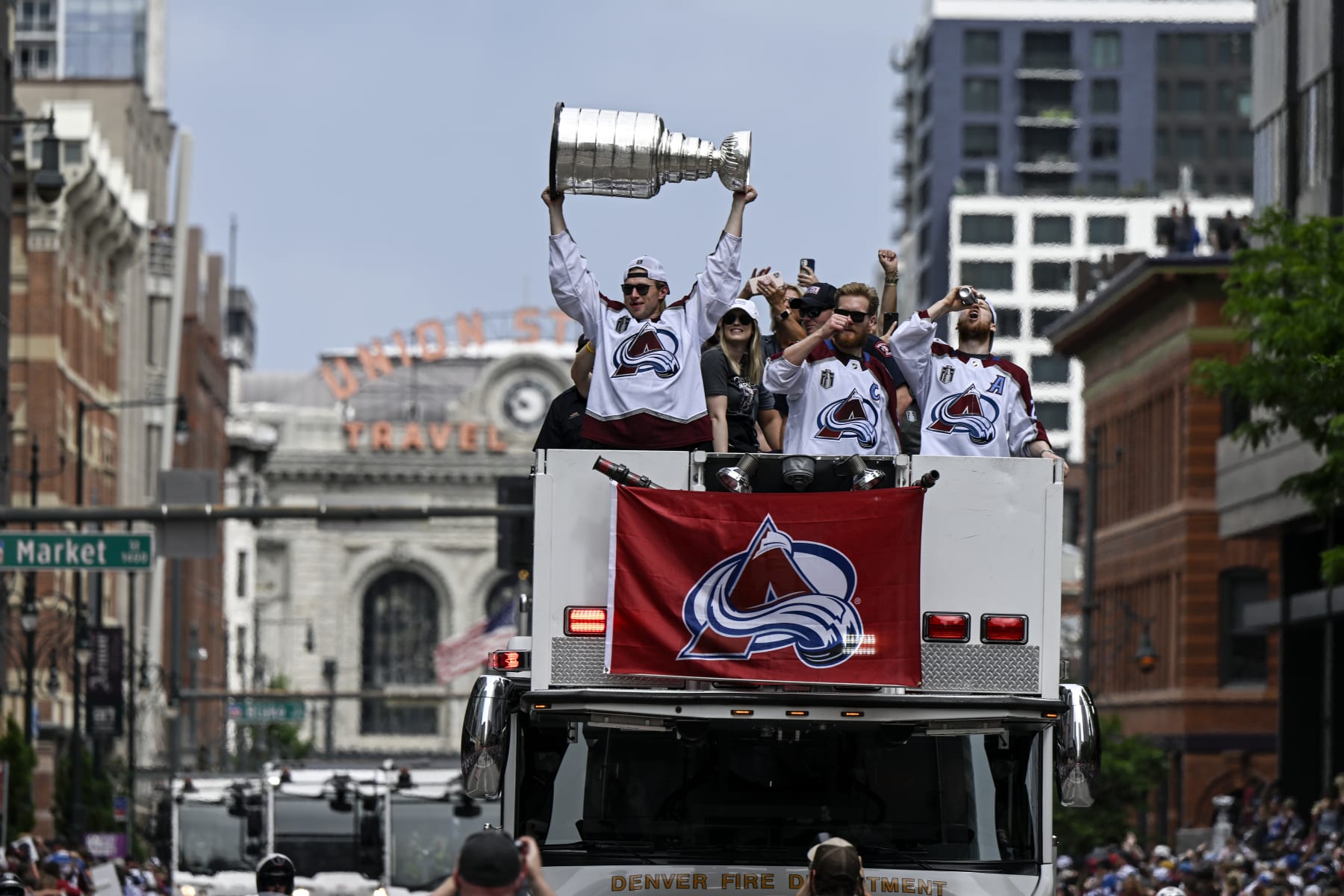 DENVER, CO - JUNE 30: Erik Johnson (6) hoists the cup as he parties alongside Nathan MacKinnon (29) and Gabriel Landeskog (92) during the Colorado Avalanche Stanley Cup celebration parade in downtown Denver on Thursday, June 30, 2022. (Photo by AAron Ontiveroz/The Denver Post)