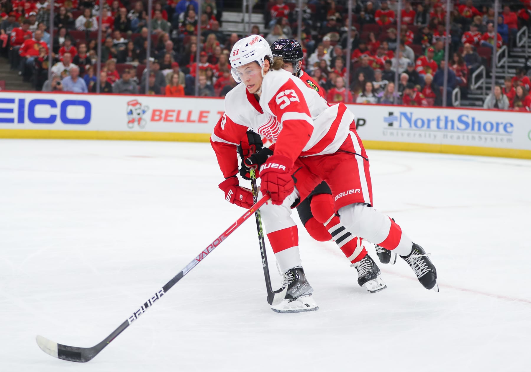 CHICAGO, IL - OCTOBER 01: Detroit Red Wings defenseman Moritz Seider (53) skates with the puck in action during a game between the Detroit Red Wings and the Chicago Blackhawks on October 1, 2022 at the United Center in Chicago, IL. (Photo by Melissa Tamez/Icon Sportswire via Getty Images)