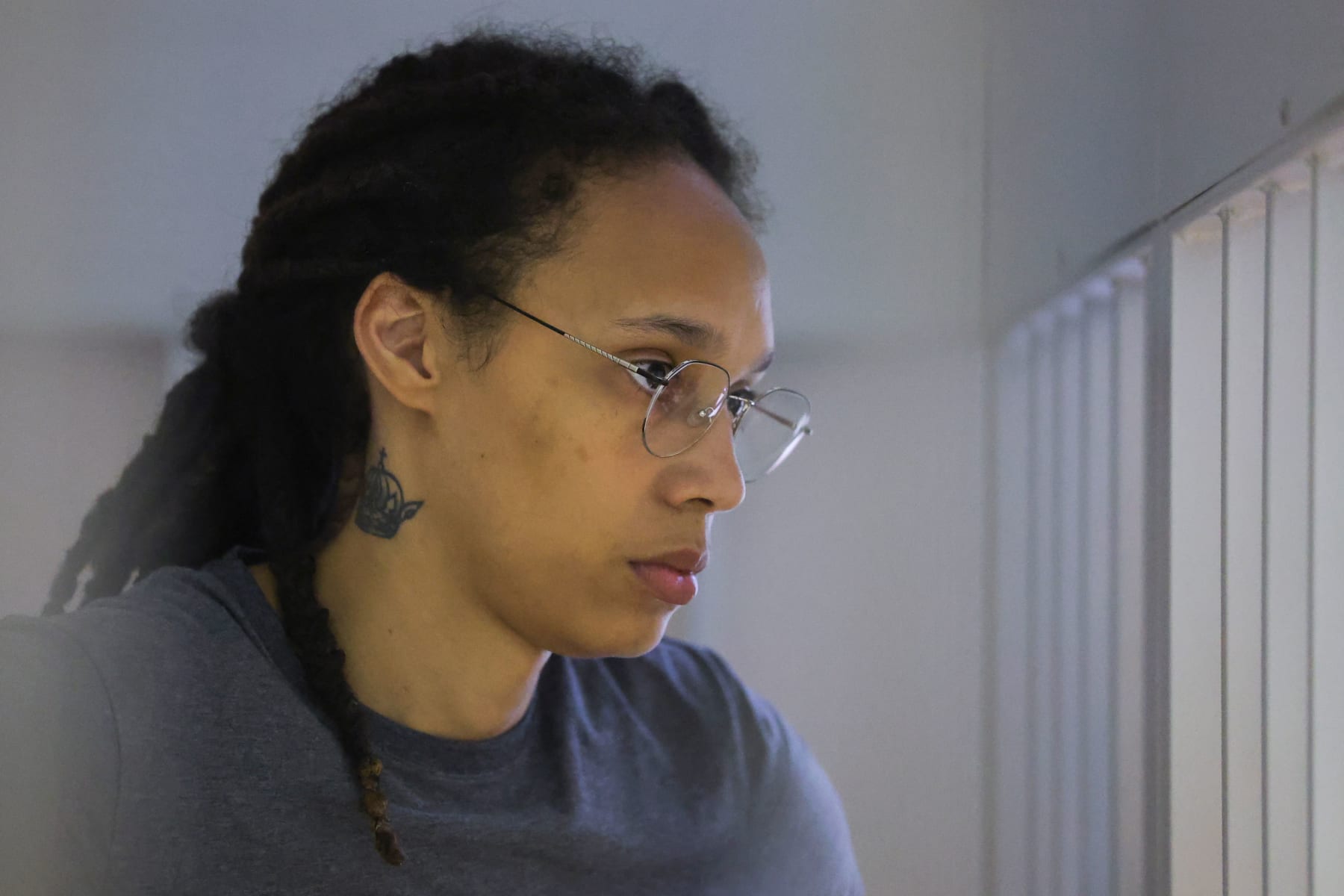 US' Women's National Basketball Association (WNBA) basketball player Brittney Griner, who was detained at Moscow's Sheremetyevo airport and later charged with illegal possession of cannabis, waits for the verdict inside a defendants' cage during a hearing in Khimki outside Moscow, on August 4, 2022. - A Russian court found Griner guilty of smuggling and storing narcotics after prosecutors requested a sentence of nine and a half years in jail for the athlete. (Photo by EVGENIA NOVOZHENINA / POOL / AFP) (Photo by EVGENIA NOVOZHENINA/POOL/AFP via Getty Images)