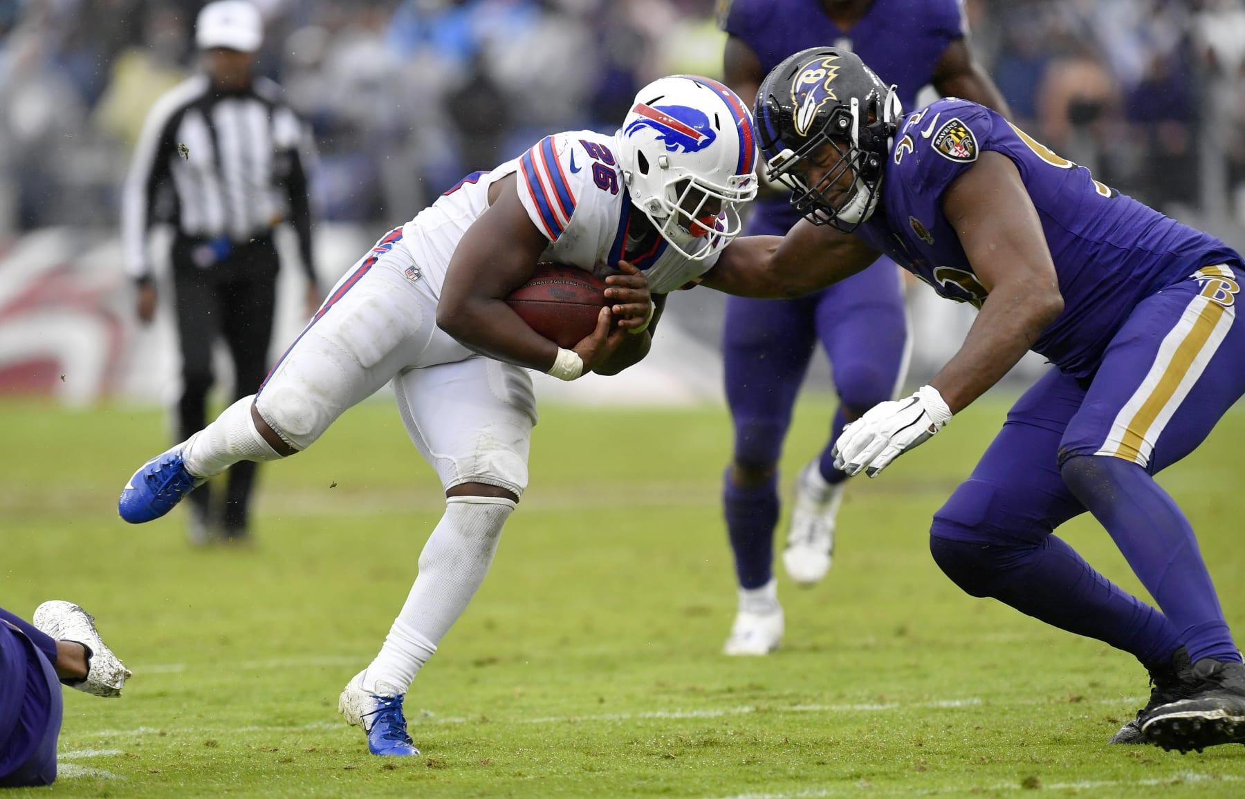 Baltimore Ravens' Chuck Clark (36), left, is unable to bring down Buffalo  Bills quarterback Josh Allen (17) during the Bills' final drive of the game  on Sunday, Dec. 8, 2019 at New