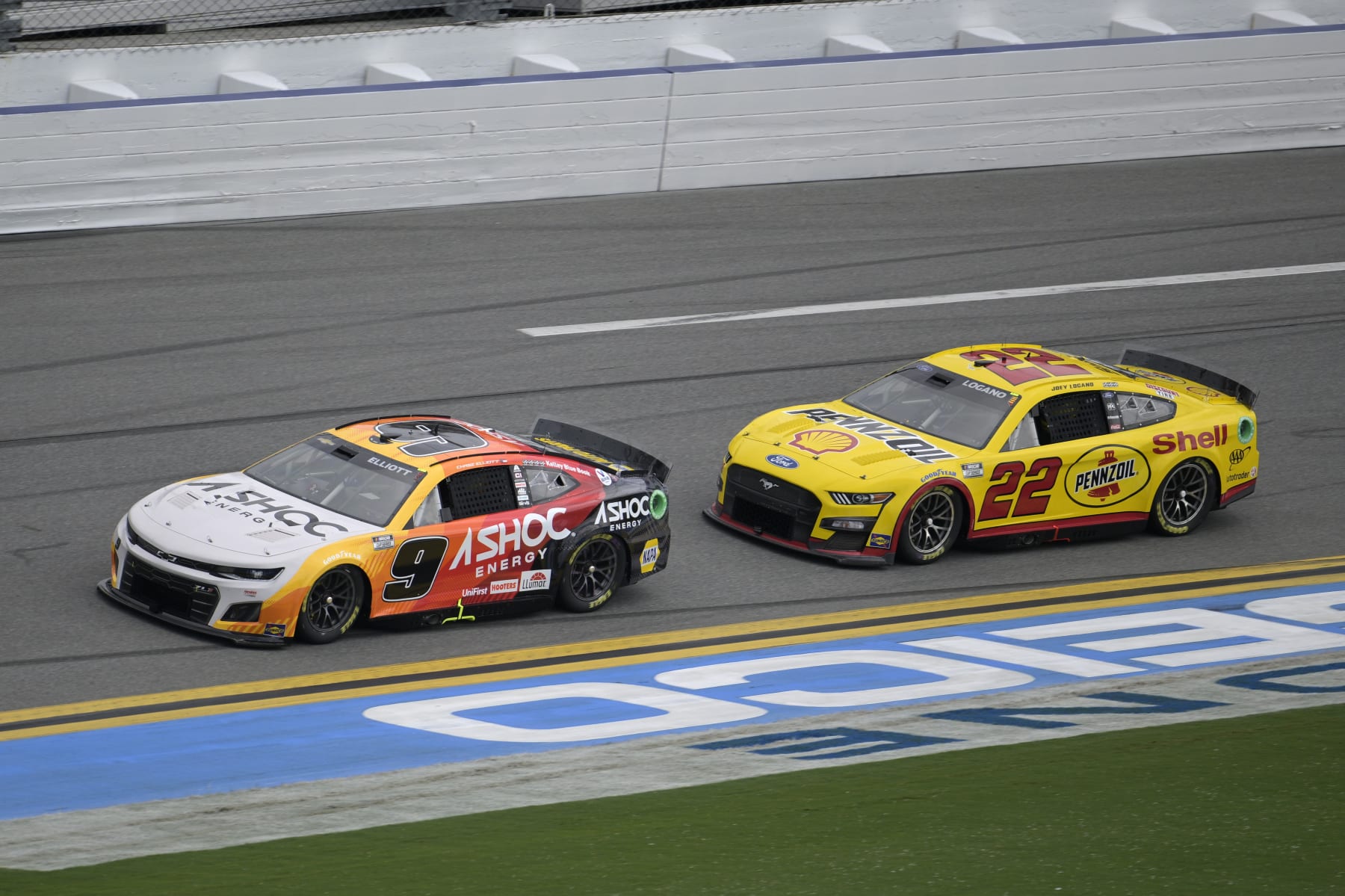 Chase Elliott (9) and Joey Logano (22) drive along the front stretch during a NASCAR Cup Series auto race at Daytona International Speedway, Sunday, Aug. 28, 2022, in Daytona Beach, Fla. (AP Photo/Phelan M. Ebenhack)