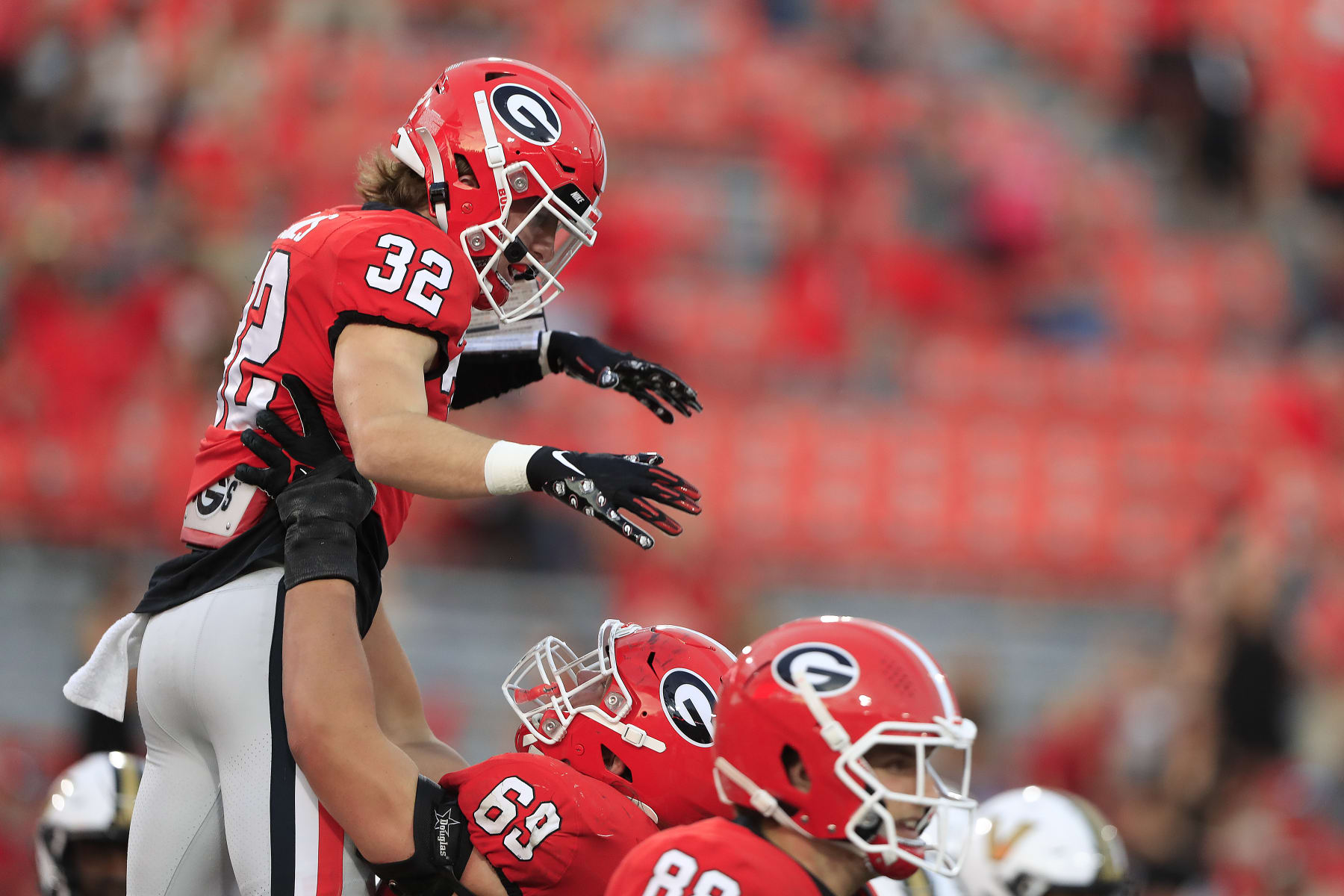 ATHENS, GA - OCTOBER 15: Georgia Bulldogs running back Cash Jones (32) is lifted in the air after scoring a touchdown during the college football game between the Georgia Bulldogs and the Vanderbilt Commodores on October 15, 2022 at Sanford Stadium in Athens, GA. (Photo by David J. Griffin/Icon Sportswire via Getty Images)