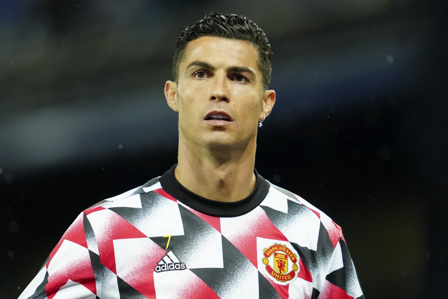 Manchester United's Cristiano Ronaldo walks on to the pitch for the warmup before the Premier League soccer match between Everton and Manchester United at Goodison Park, in Liverpool, England, Sunday Oct. 9, 2022. Ronaldo will start the match on the bench. (AP Photo/Jon Super)