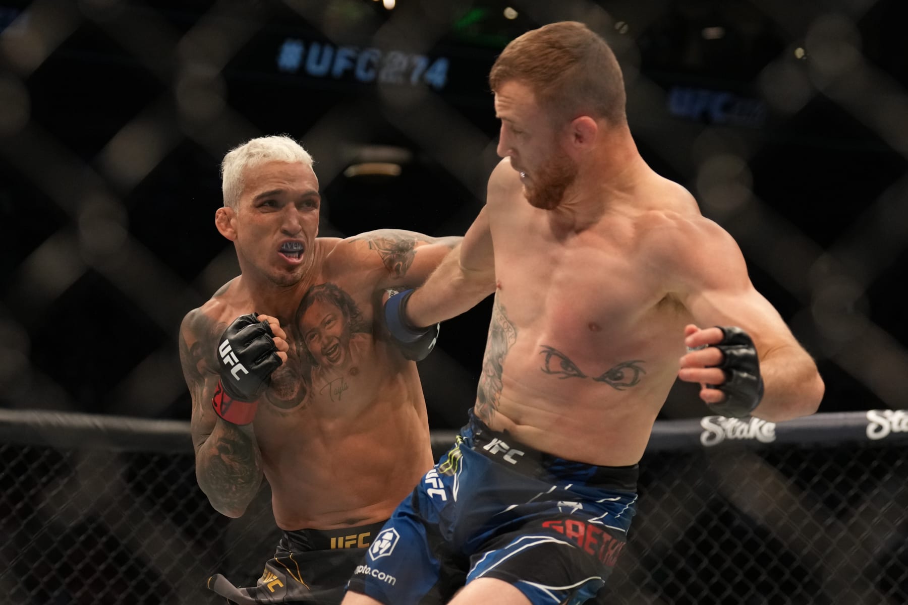 PHOENIX, AZ - MAY 7: (L-R) Charles Oliveira punches Justin Gaethje in their Lightweight bout during the UFC 274 event at Footprint Center on May 7, 2022, in Phoenix, Arizona. (Photo by Louis Grasse/PxImages/Icon Sportswire via Getty Images)