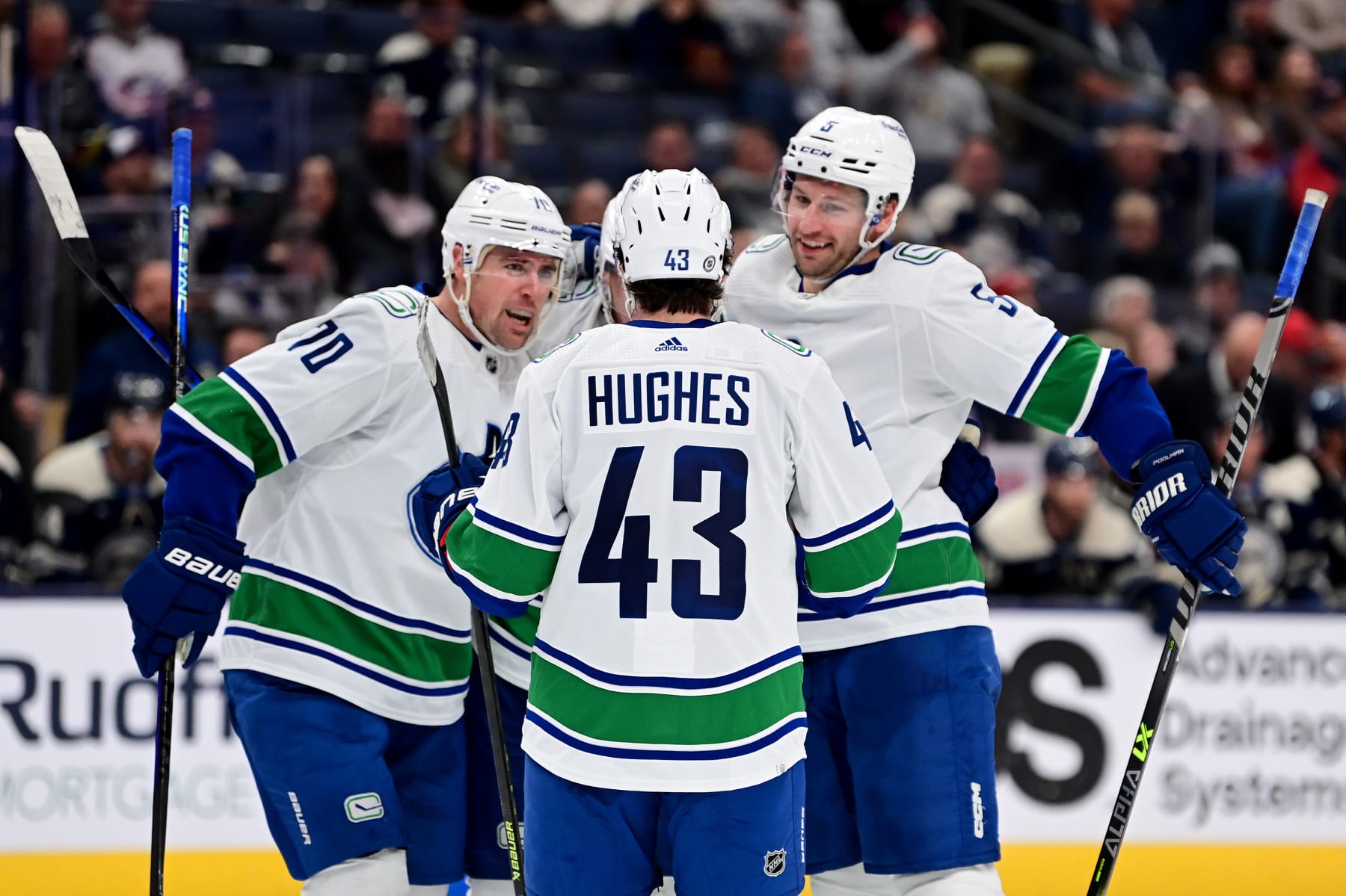 COLUMBUS, OHIO - OCTOBER 18: Bo Horvat #53 celebrates his goal with teammates Tanner Pearson #70, Quinn Hughes #43 and Tucker Poolman #5 of the Vancouver Canucks during the third period against the Columbus Blue Jackets at Nationwide Arena on October 18, 2022 in Columbus, Ohio. (Photo by Emilee Chinn/Getty Images)