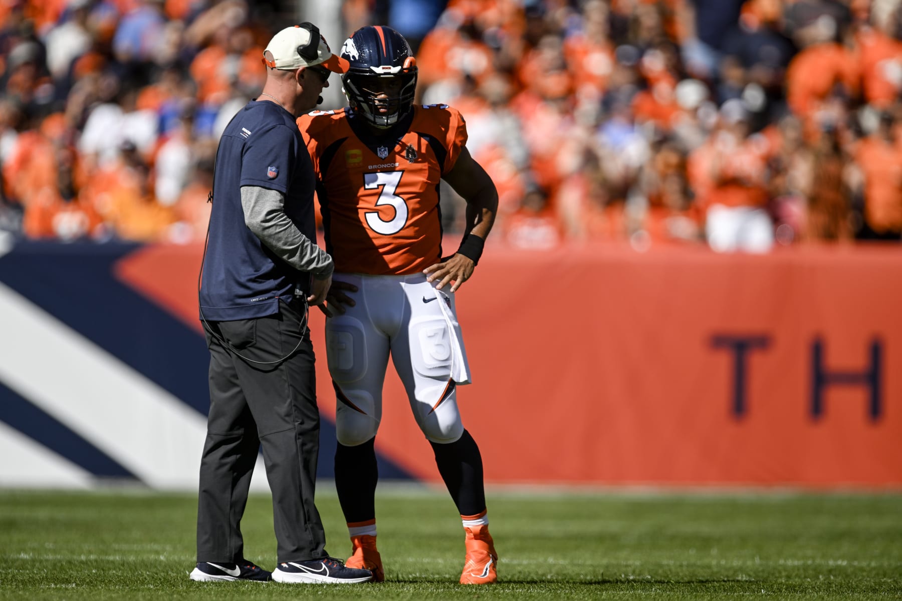 Denver Broncos QB Russell Wilson adjusts to pressure from defense