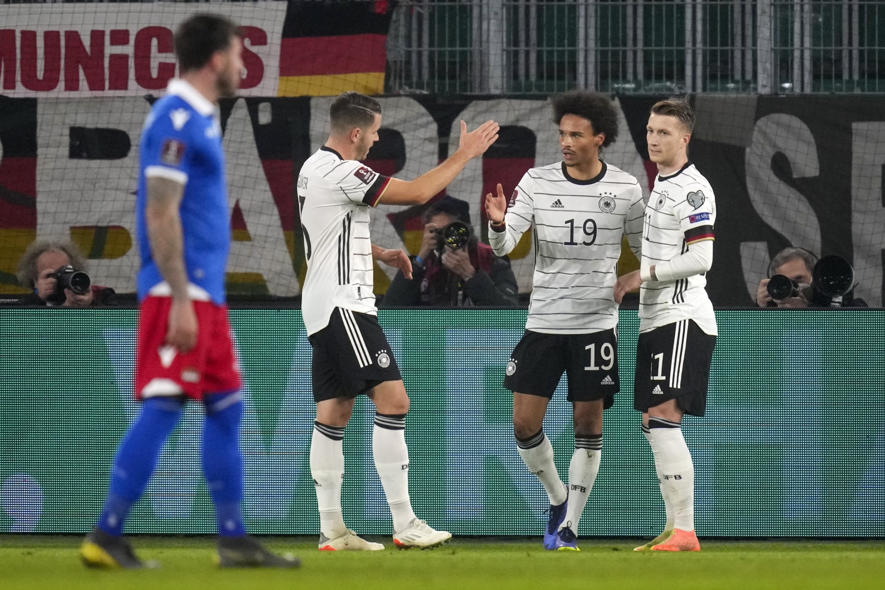 Germany's Leroy Sane, second right, is congratulated by teammates after scoring his team's third goal during the World Cup 2022 group J qualifying soccer match between Germany and Liechtenstein in Wolfsburg, Germany, Thursday, Nov. 11, 2021. (AP Photo/Michael Sohn)