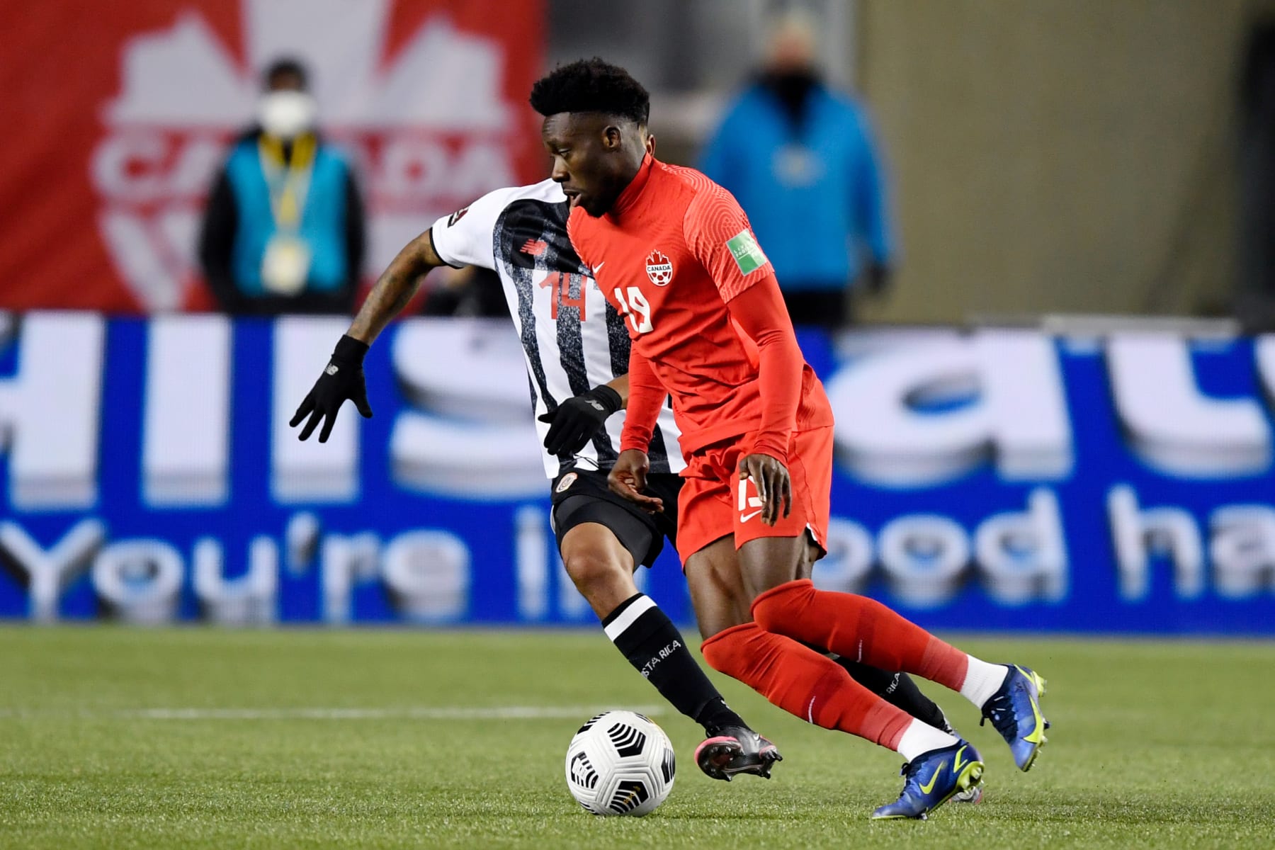 EDMONTON, CANADA - NOVEMBER 12: Orlando Galo of Costa Rica, Alphonso Davies of Canada during the World Cup Qualifier match between Canada v Costa Rica at the Commonwealth Stadium on November 12, 2021 in Edmonton Canada (Photo by Dale Macmillan/Soccrates/Getty Images)
