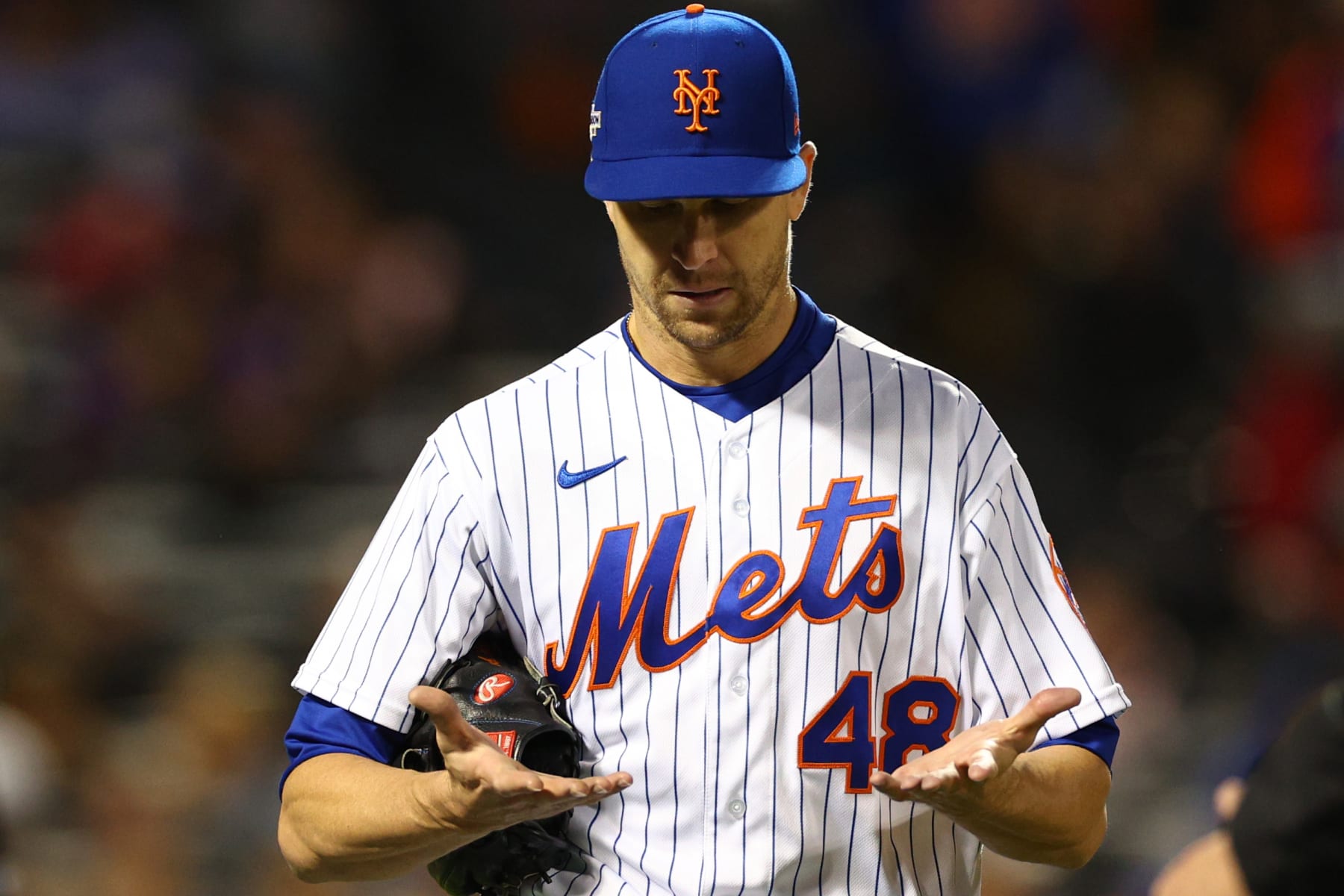 NEW YORK, NEW YORK - OCTOBER 08: Jacob deGrom #48 of the New York Mets shows his hands to the umpire following the fourth inning against the San Diego Padres in game two of the Wild Card Series at Citi Field on October 08, 2022 in New York City. (Photo by Elsa/Getty Images)
