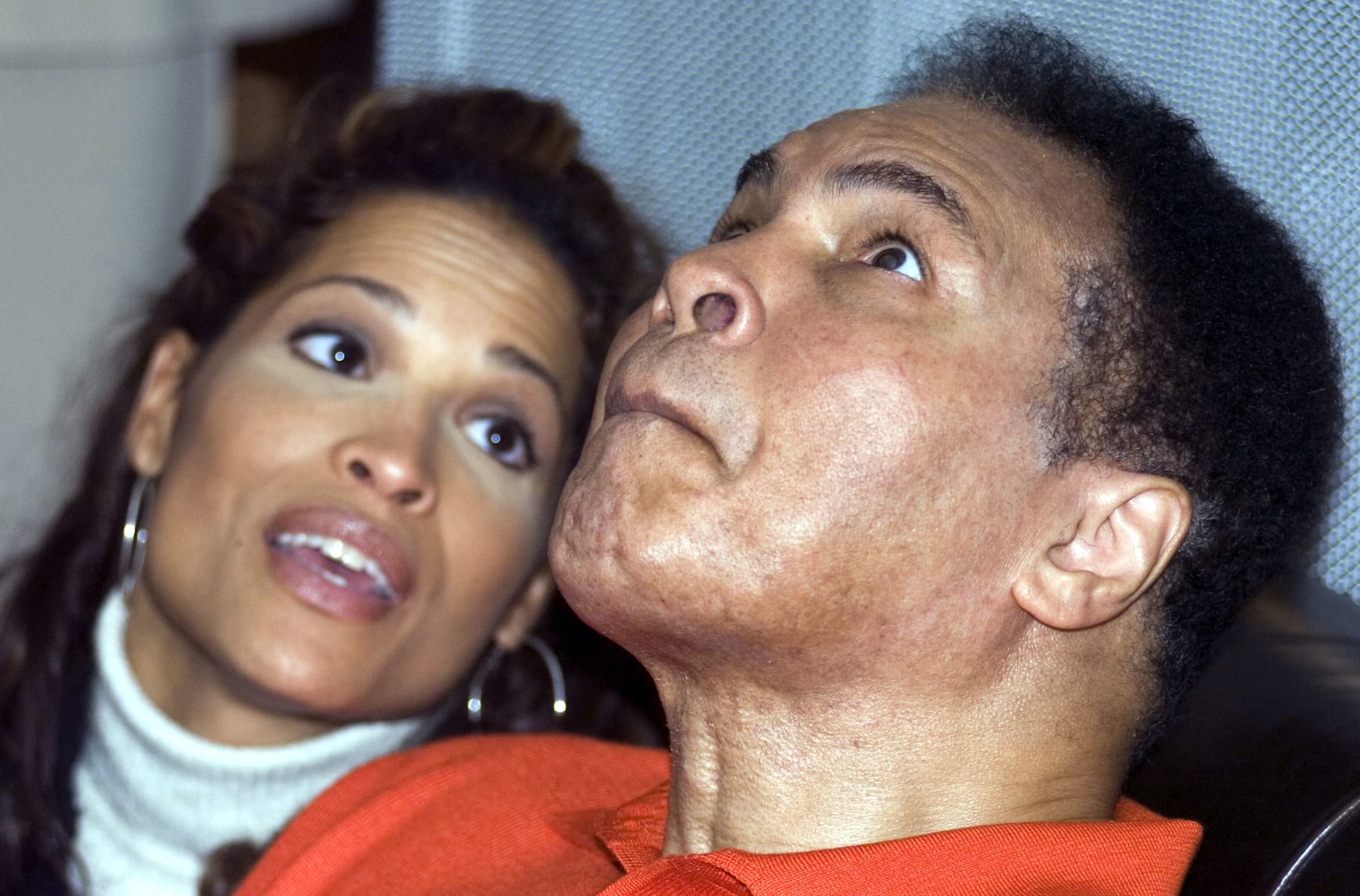 LOUISVILLE, KY - NOVEMBER 18:  Muhammad Ali watches a younger version of himself on a big screen with amazement as his daughter, Rasheda Ali-Walsh, looks on at the media opening of the Muhammad Ali Center on November 18, 2005 in Louisville, Kentucky. The $75 million center, which honors the life and career of the boxing legend, opens to the public November 21.  (Photo by David Lutman/Getty Images)