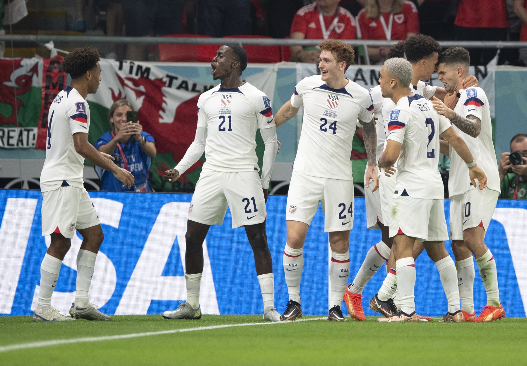 DOHA, QATAR - NOVEMBER 21: Timothy Weah of USA celebrates scoring with team mates Tyler Adams, Joshua Sargent, Antonee Robinson, Sergino Dest and Christian Pulisic during the FIFA World Cup Qatar 2022 Group B match between USA and Wales at Ahmad Bin Ali Stadium on November 21, 2022 in Doha, Qatar. (Photo by Visionhaus/Getty Images)
