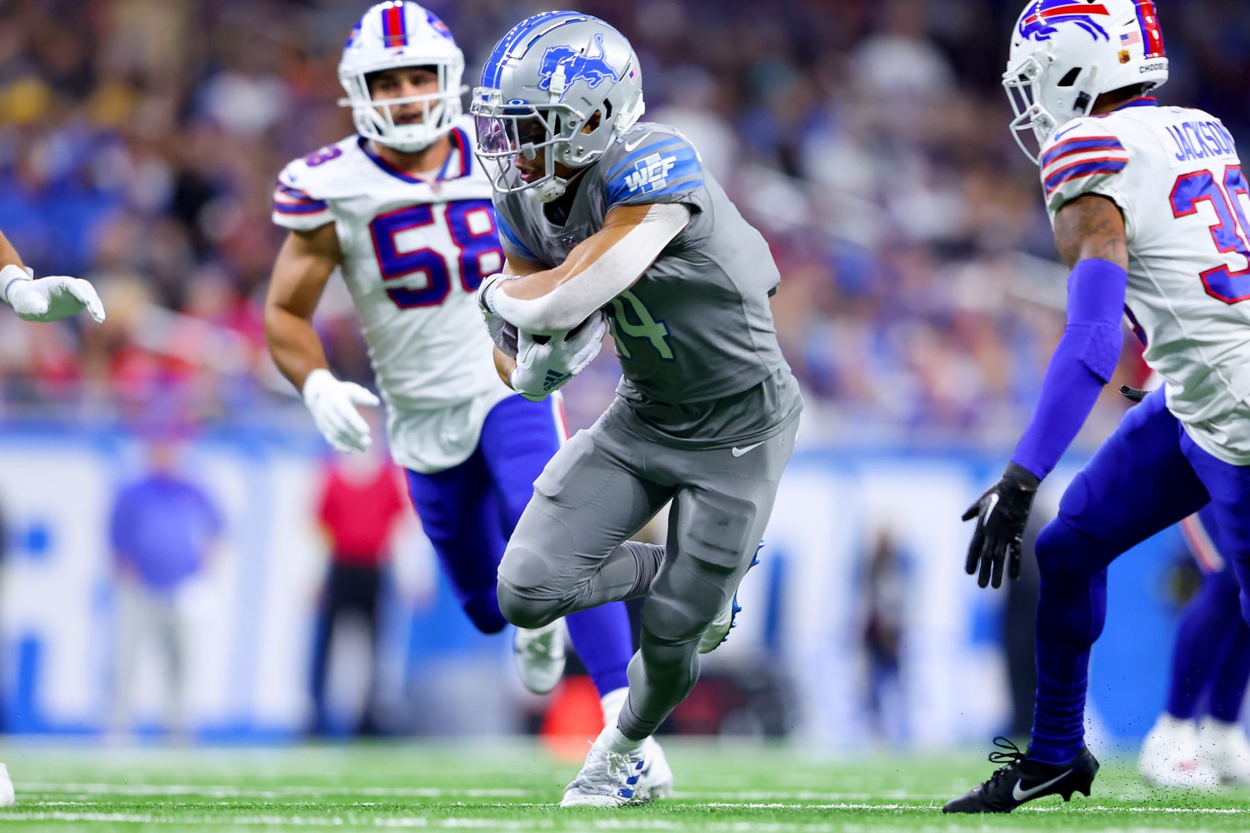 Amon-Ra St. Brown of the Detroit Lions runs with the ball as