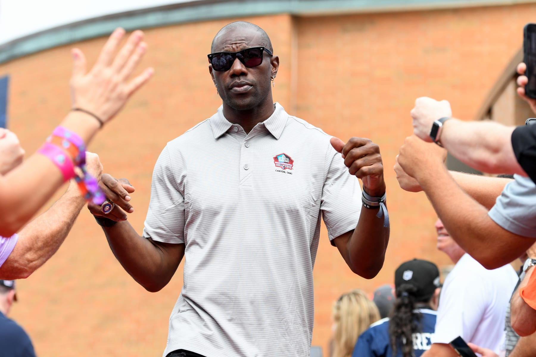 CANTON, OHIO - AUGUST 06: Hall of Fame wide receiver Terrell Owens celebrates with fans as he is introduced prior to the 2022 Pro Hall of Fame Enshrinement Ceremony at Tom Benson Hall of Fame Stadium on August 06, 2022 in Canton, Ohio. (Photo by Nick Cammett/Getty Images)