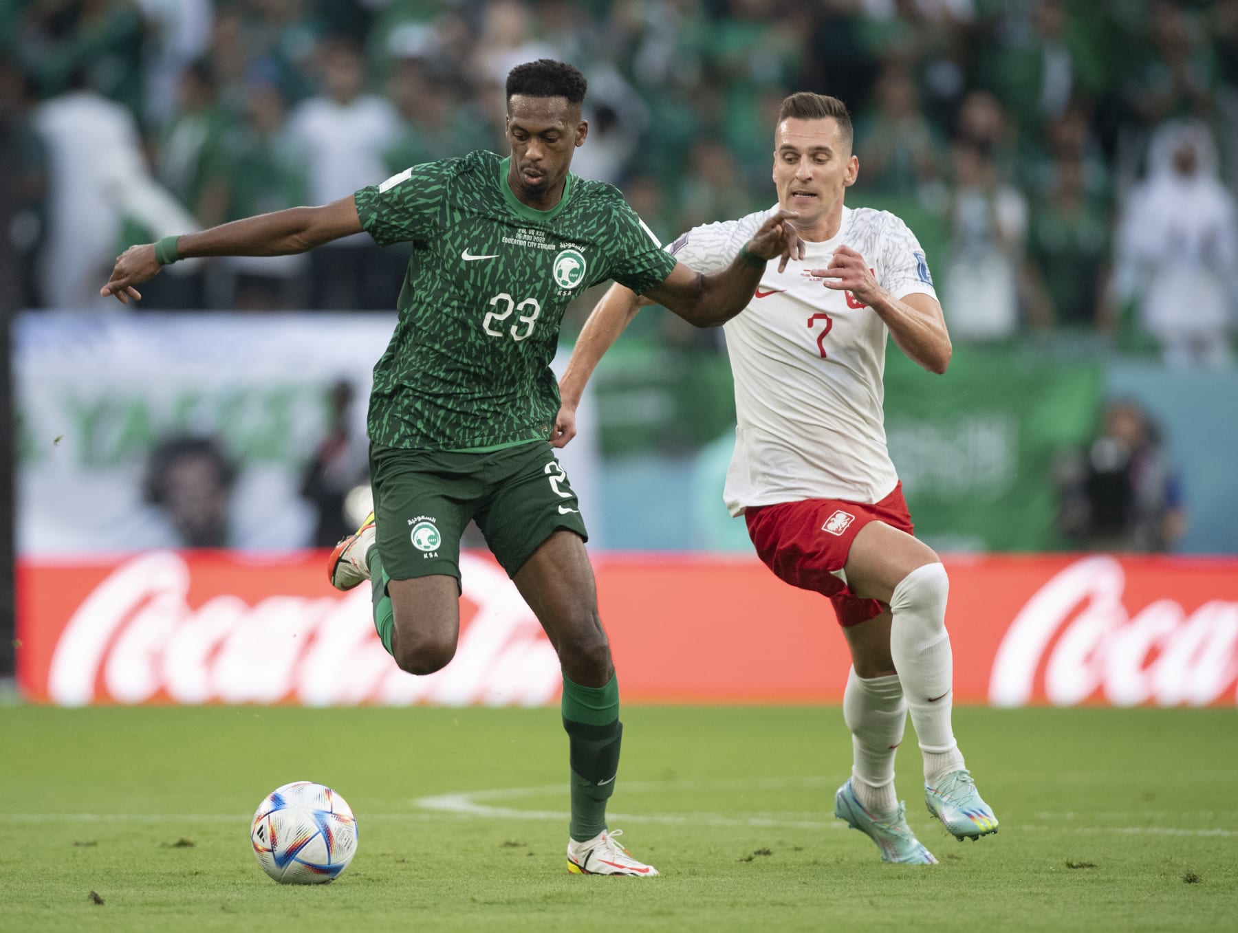 AL RAYYAN, QATAR - NOVEMBER 26: Arkadiusz Milik of Poland and Mohamed Kanno of Saudi Arabia in action during the FIFA World Cup Qatar 2022 Group C match between Poland and Saudi Arabia at Education City Stadium on November 26, 2022 in Al Rayyan, Qatar. (Photo by Visionhaus/Getty Images)