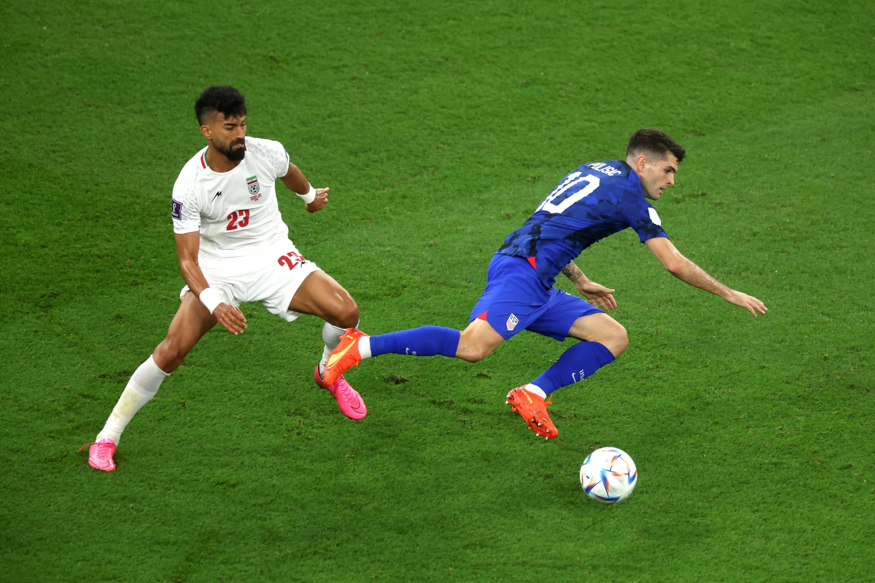DOHA, QATAR - NOVEMBER 29: Christian Pulisic of United States battles for possession with Ramin Rezaeian of IR Iran during the FIFA World Cup Qatar 2022 Group B match between IR Iran and USA at Al Thumama Stadium on November 29, 2022 in Doha, Qatar. (Photo by Alex Grimm/Getty Images)