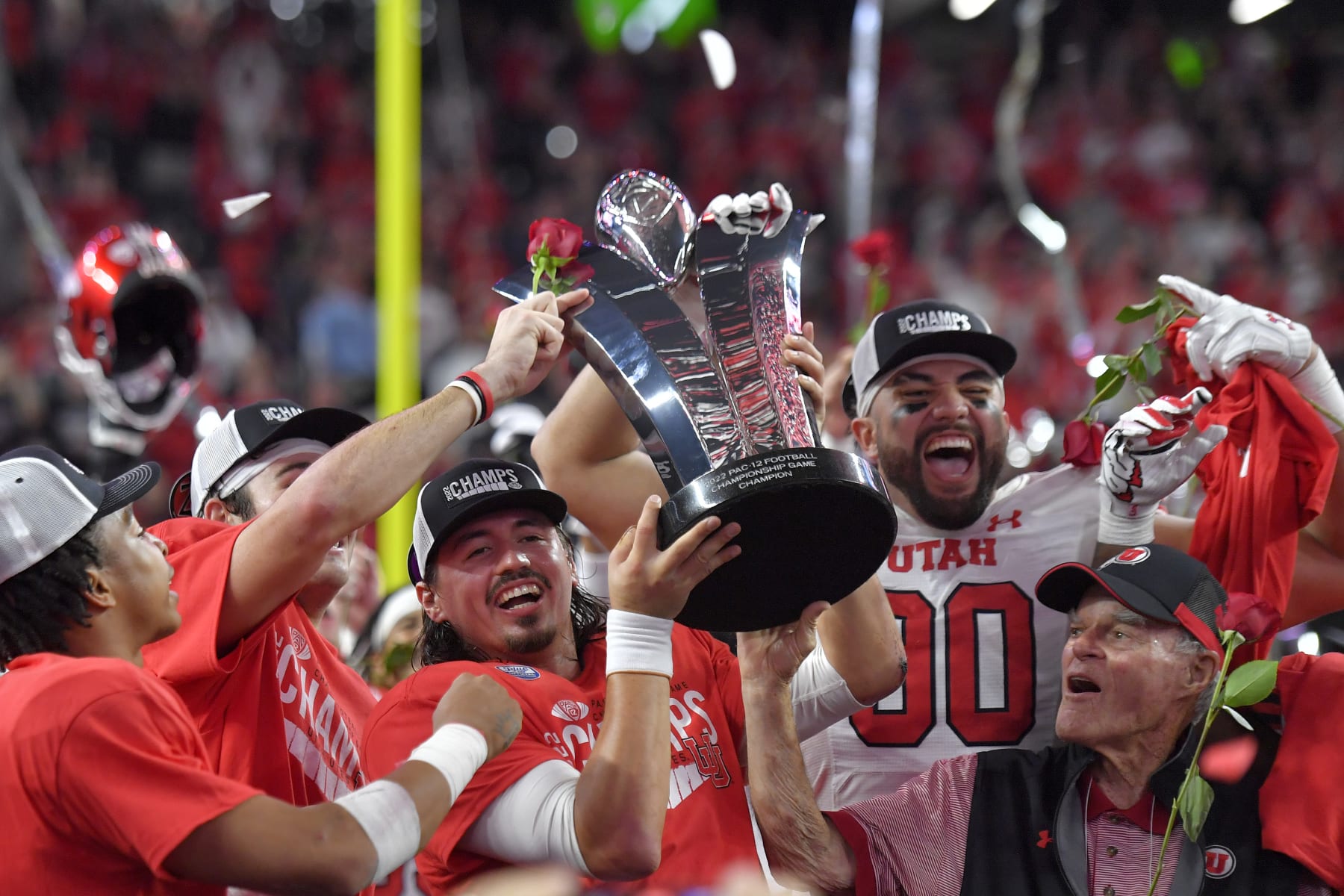 LAS VEGAS, NEVADA - DECEMBER 02: Cameron Rising #7 and Devin Kaufusi #90 of the Utah Utes celebrate with the Schwabacher Trophy after defeating the USC Trojans in the Pac-12 Championship at Allegiant Stadium on December 02, 2022 in Las Vegas, Nevada. (Photo by David Becker/Getty Images)
