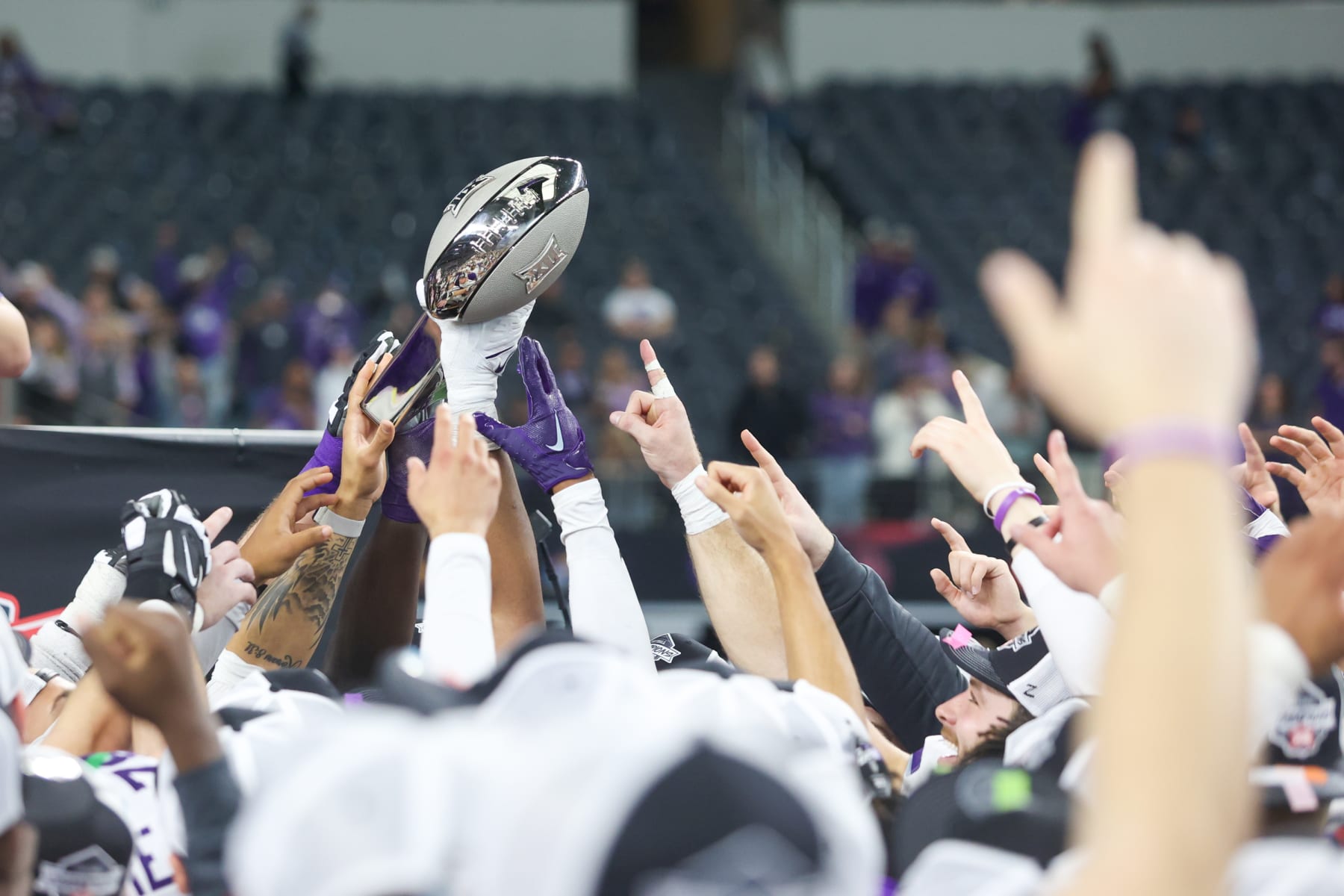 ARLINGTON, TX - DECEMBER 03: Kansas State Wildcats players celebrate with the trophy after winning the Big 12 Championship game between TCU and Kansas State on December 3, 2022 at AT&T Stadium in Arlington, TX. (Photo by George Walker/Icon Sportswire via Getty Images)
