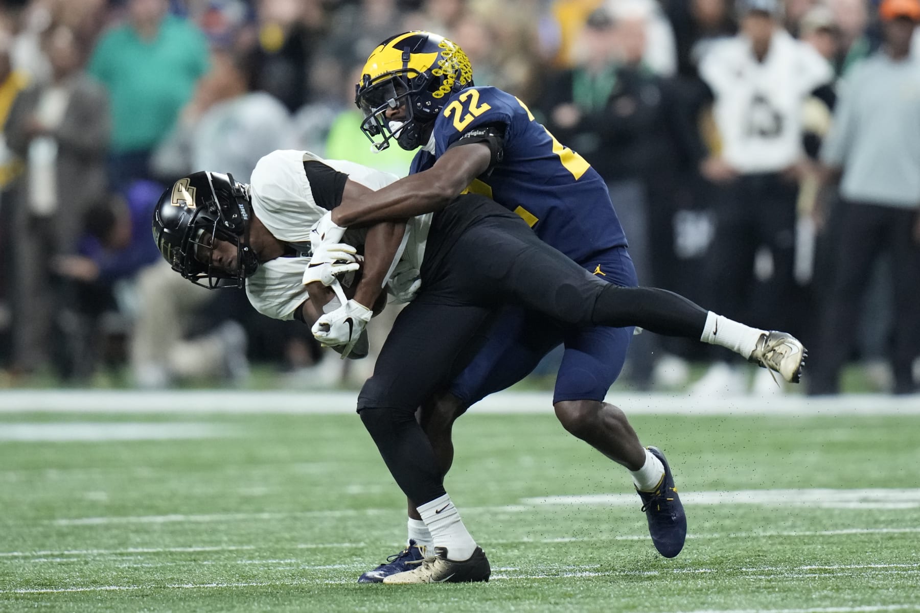 Purdue wide receiver TJ Sheffield runs with the ball as Michigan defensive back Gemon Green (22) defends during the first half of the Big Ten championship NCAA college football game, Saturday, Dec. 3, 2022, in Indianapolis. (AP Photo/AJ Mast)