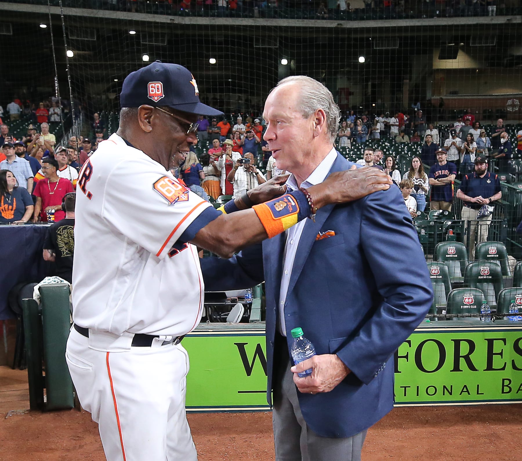 HOUSTON, TEXAS - MAY 03: Manager Dusty Baker Jr. #12 of the Houston Astros is congratulated by Houston Astros owner Jim Crane on his 2000th career win after a game against the Seattle Mariners at Minute Maid Park on May 03, 2022 in Houston, Texas. (Photo by Bob Levey/Getty Images)