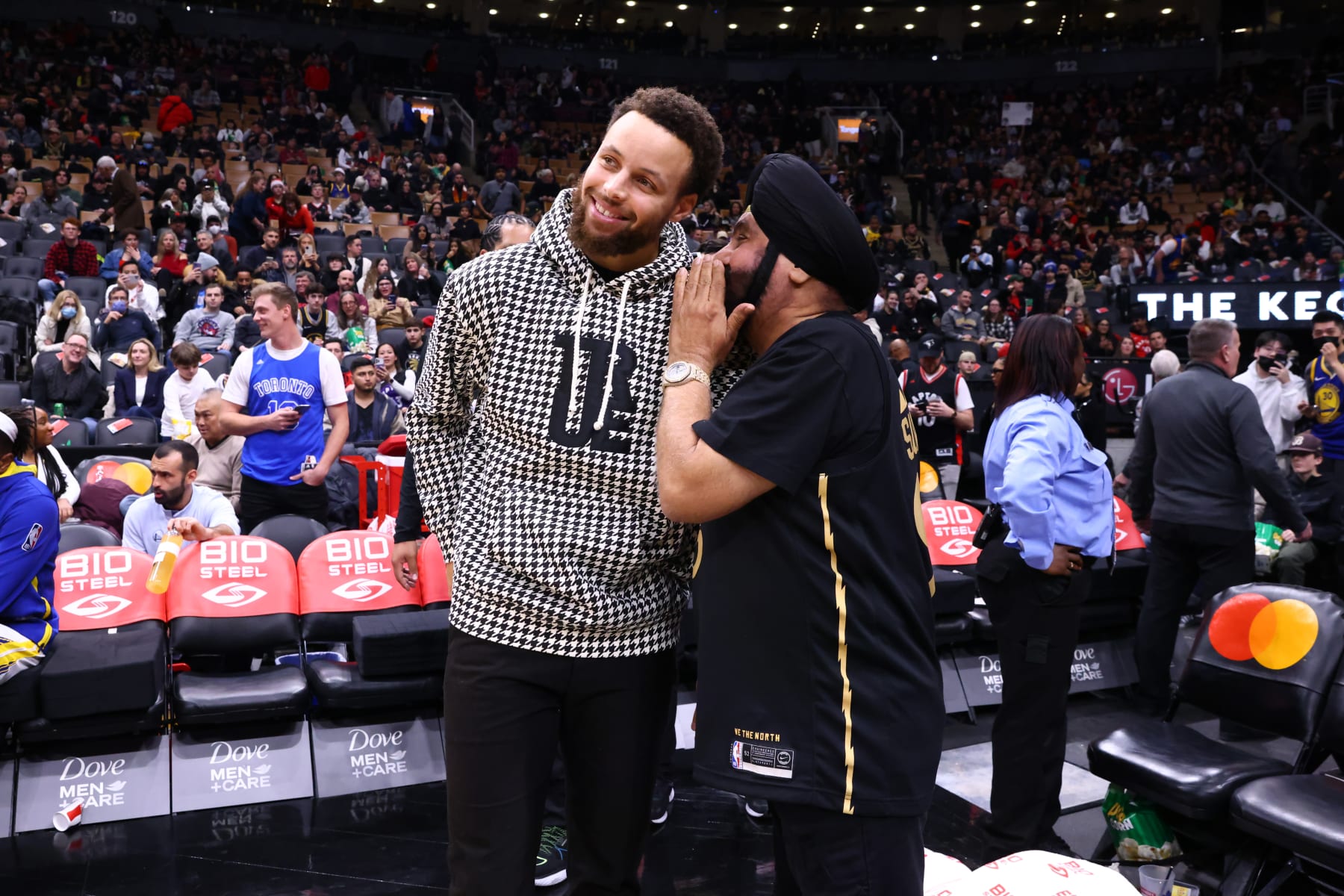 TORONTO, CANADA - DECEMBER 18: Stephen Curry #30 of the Golden State Warriors talks with Toronto Raptors Super Fan, Nav Bhatia on December 18, 2022 at the Scotiabank Arena in Toronto, Ontario, Canada. NOTE TO USER: User expressly acknowledges and agrees that, by downloading and or using this Photograph, user is consenting to the terms and conditions of the Getty Images License Agreement. Mandatory Copyright Notice: Copyright 2022 NBAE (Photo by Vaughn Ridley/NBAE via Getty Images)