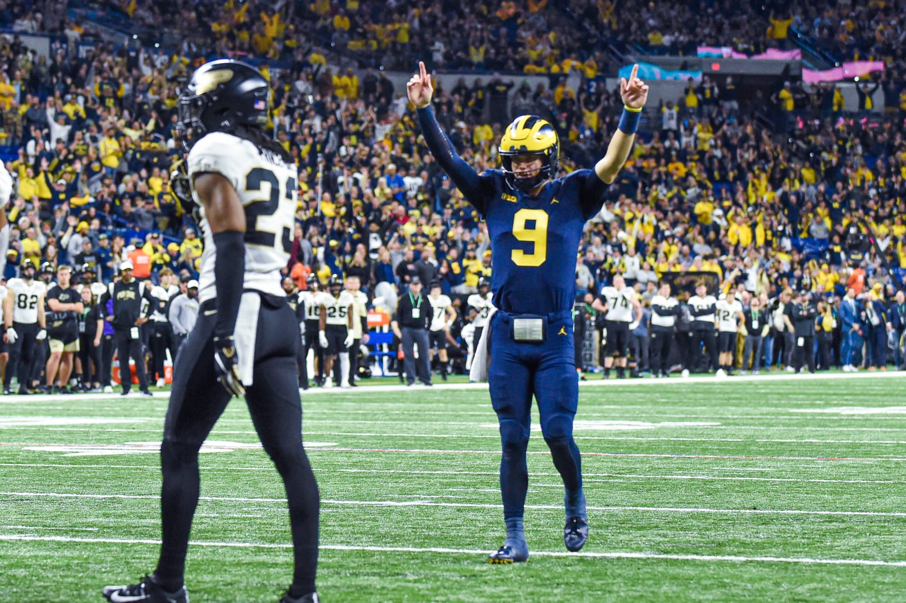 INDIANAPOLIS, INDIANA - DECEMBER 03: J.J. McCarthy #9 of the Michigan Wolverines reacts after his teams scores a touchdown during the second half of the Big Ten football championship game against the Purdue Boilermakers at Lucas Oil Stadium on December 03, 2022 in Indianapolis, Indiana. The Michigan Wolverines won the game 43-22 over the Purdue Boilermakers. (Photo by Aaron J. Thornton/Getty Images)