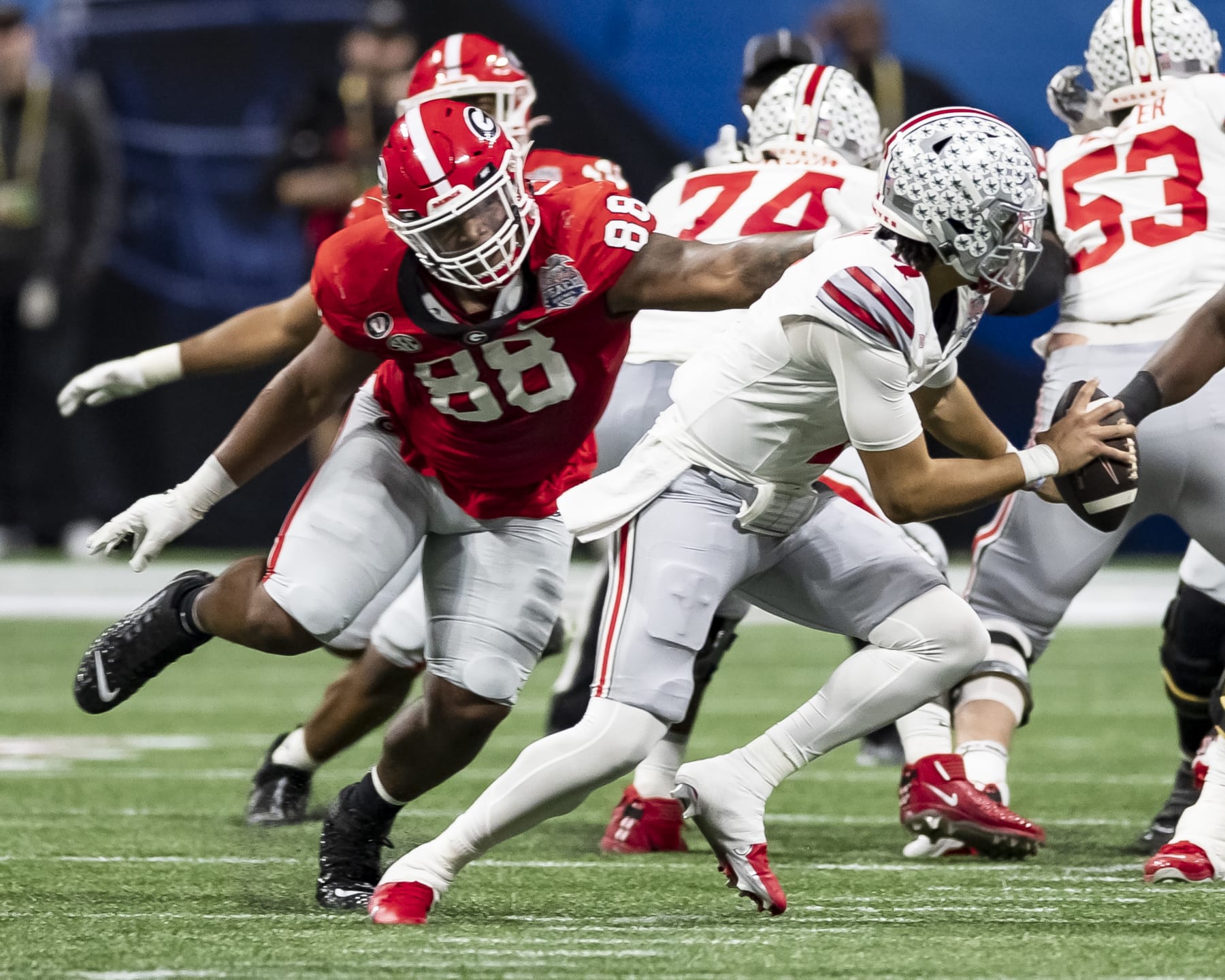 ATLANTA, GA - DECEMBER 31: C.J. Stroud #7 of the Ohio State Buckeyes avoids a sack by Jalen Carter #88 of the Georgia Bulldogs during a game between Ohio State Buckeyes and Georgia Bulldogs at Mercedes-Benz Stadium on December 31, 2022 in Atlanta, Georgia. (Photo by Steve Limentani/ISI Photos/Getty Images)