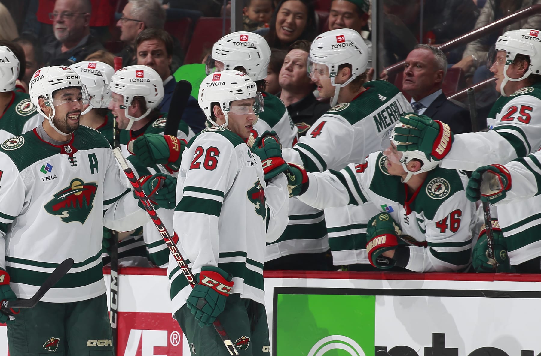 VANCOUVER, CANADA - DECEMBER 10: Connor Dewar #26 of the Minnesota Wild celebrates his goal with teammates during the second period of their NHL game against the Vancouver Canucks at Rogers Arena December 10, 2022 in Vancouver, British Columbia, Canada. (Photo by Jeff Vinnick/NHLI via Getty Images)