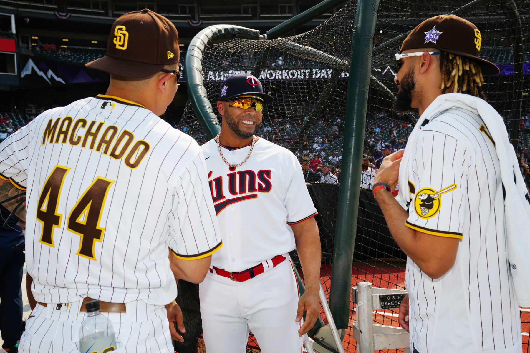 DENVER, CO - JULY 12: Nelson Cruz #23 of the Minnesota Twins laughs with Manny Machado #13 and Fernando Tatis Jr. #23 of the San Diego Padres during the 2021 Gatorade All-Star Workout Day at Coors Field on Monday, July 12, 2021 in Denver, Colorado. (Photo by Daniel Shirey/MLB Photos via Getty Images)