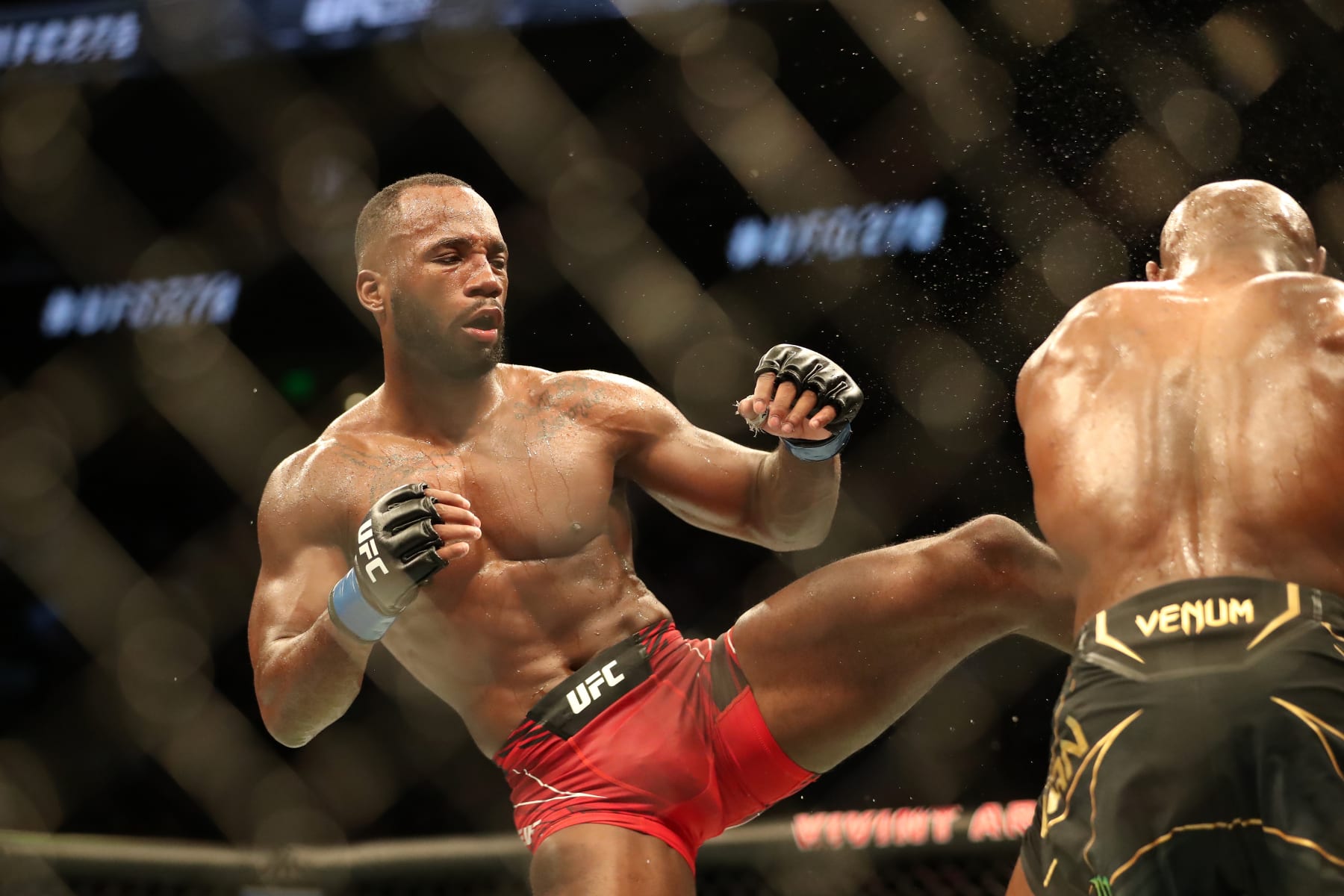 Leon Edwards kicks Kamaru Usman.