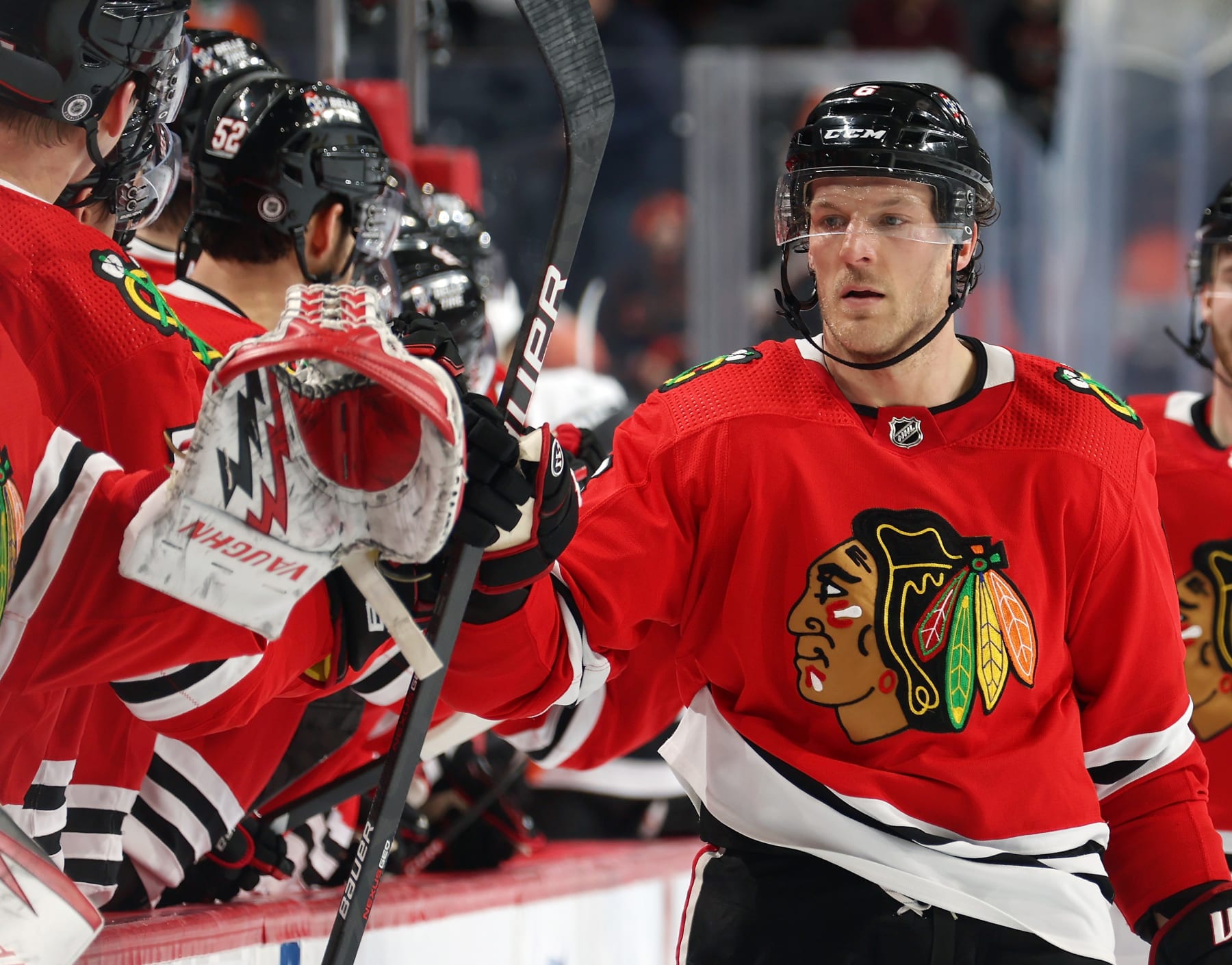 PHILADELPHIA, PENNSYLVANIA - JANUARY 19: Jake McCabe #6 of the Chicago Blackhawks celebrates a third period goal with teammates on the bench against the Philadelphia Flyers at the Wells Fargo Center on January 19, 2023 in Philadelphia, Pennsylvania. (Photo by Len Redkoles/NHLI via Getty Images)