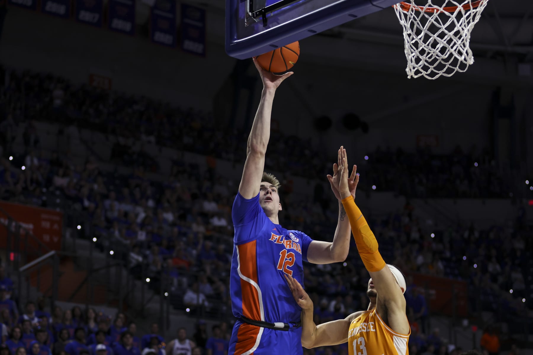 GAINESVILLE, FLORIDA - FEBRUARY 01: Colin Castleton #12 of the Florida Gators shoots the ball against Olivier Nkamhoua #13 of the Tennessee Volunteers during the first half of a game at the Stephen C. O'Connell Center on February 01, 2023 in Gainesville, Florida. (Photo by James Gilbert/Getty Images)