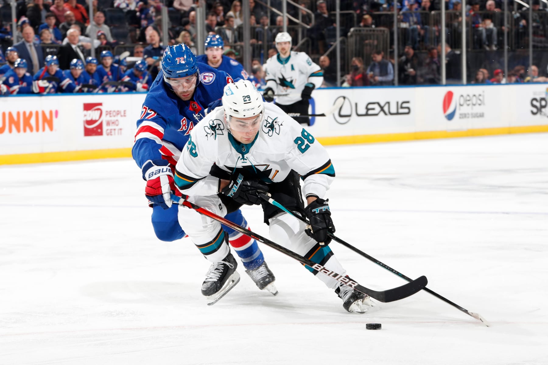 NEW YORK, NY - DECEMBER 03: Timo Meier #28 of the San Jose Sharks skates with the puck against Filip Chytil #72 of the New York Rangers at Madison Square Garden on December 3, 2021 in New York City. (Photo by Jared Silber/NHLI via Getty Images)