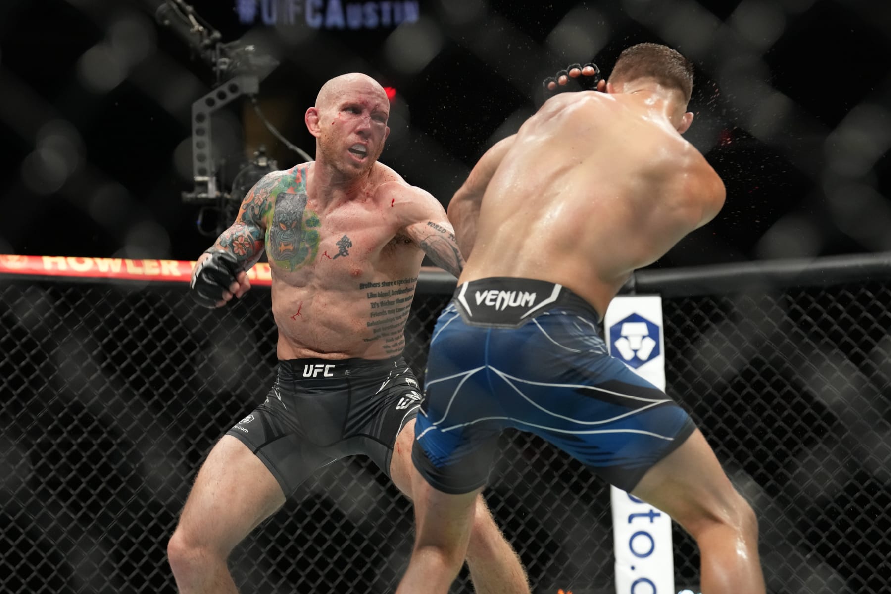 AUSTIN, TX - JUNE 18: (L-R) Josh Emmett punches Calvin Kattar in their featherweight bout during the UFC Fight Night: Kattar v Emmett event at June 18, 2022, Moody Center on in Austin, Texas. (Photo by Louis Grasse/PxImages/Icon Sportswire via Getty Images)