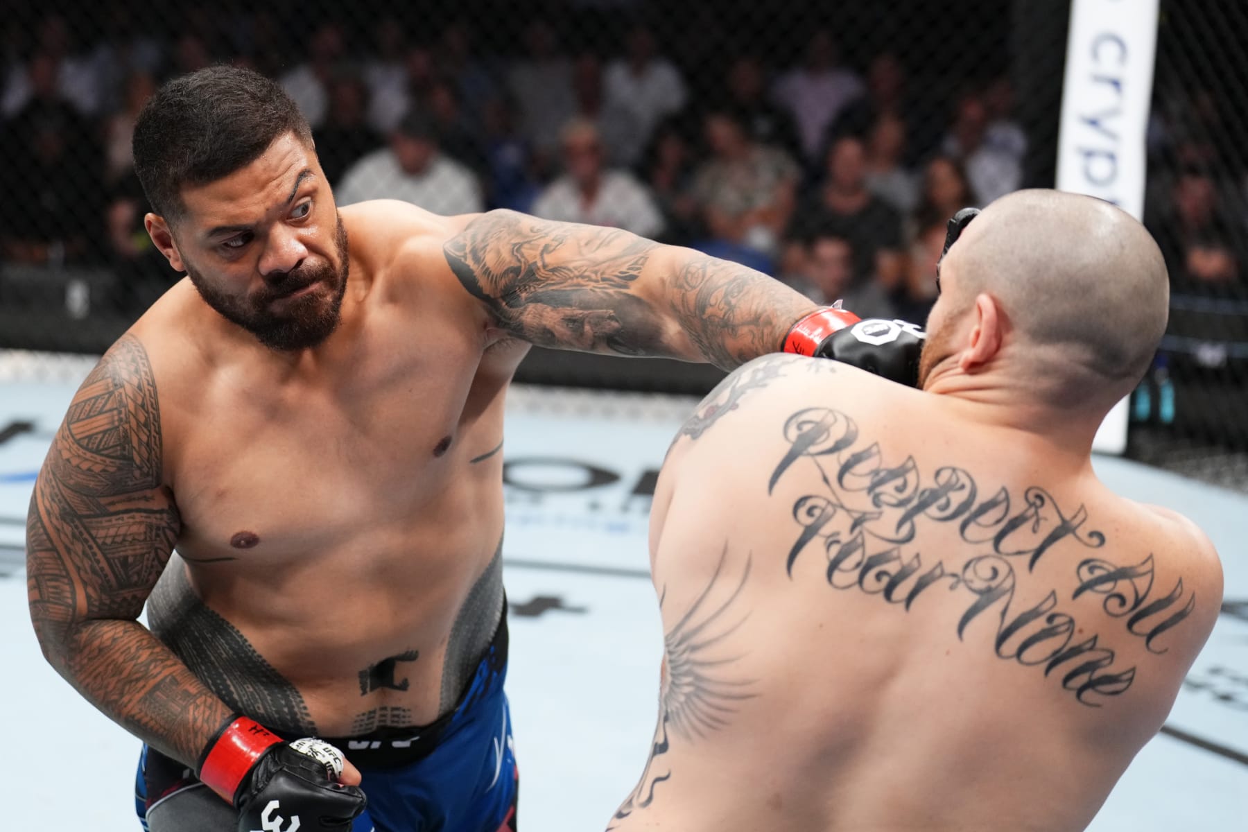 PERTH, AUSTRALIA - FEBRUARY 12: (L-R) Justin Tafa of New Zealand punches Parker Porter in a heavyweight fight during the UFC 284 event at RAC Arena on February 12, 2023 in Perth, Australia. (Photo by Chris Unger/Zuffa LLC via Getty Images)