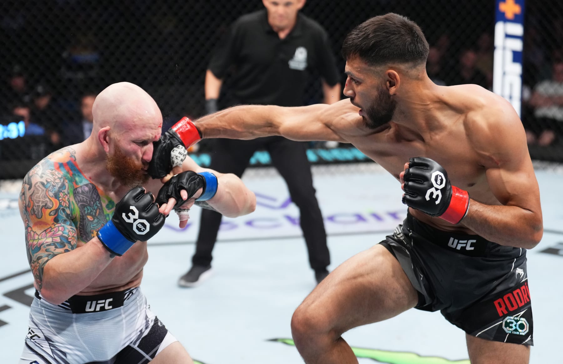PERTH, AUSTRALIA - FEBRUARY 12: (R-L) Yair Rodriguez of Mexico punches Josh Emmett in the UFC interim featherweight championship fight during the UFC 284 event at RAC Arena on February 12, 2023 in Perth, Australia. (Photo by Chris Unger/Zuffa LLC via Getty Images)