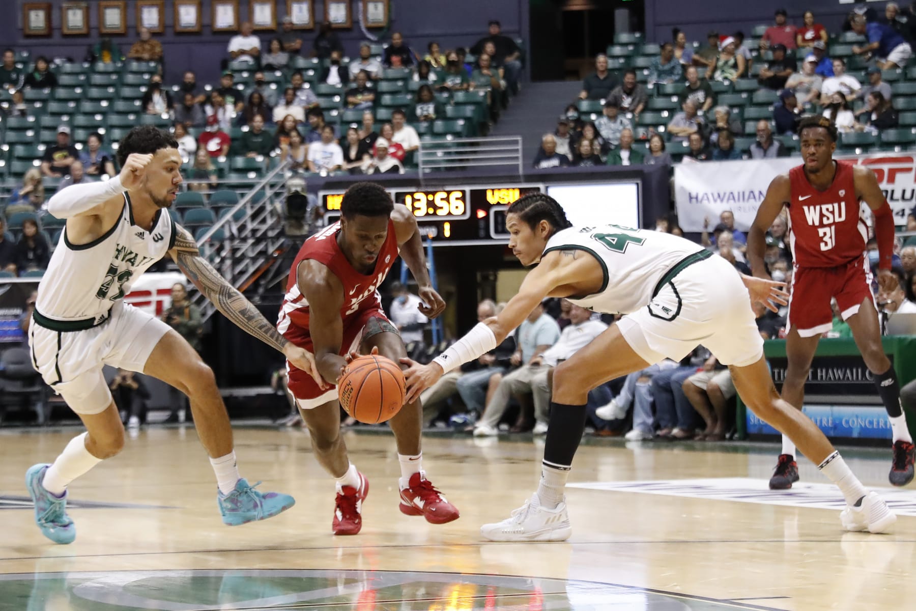 Washington State guard TJ Bamba, center, reaches for the ball between Hawaii guard Samuta Avea (32) and forward Kamaka Hepa (44) during the first half of an NCAA college basketball game Friday, Dec. 23, 2022, in Honolulu. (AP Photo/Marco Garcia) Washington State guard TJ Bamba, center, reaches for the ball between Hawaii guard Samuta Avea (32) and forward Kamaka Hepa (44) during the first half of an NCAA college basketball game Friday, Dec. 23, 2022, in Honolulu. (AP Photo/Marco Garcia)