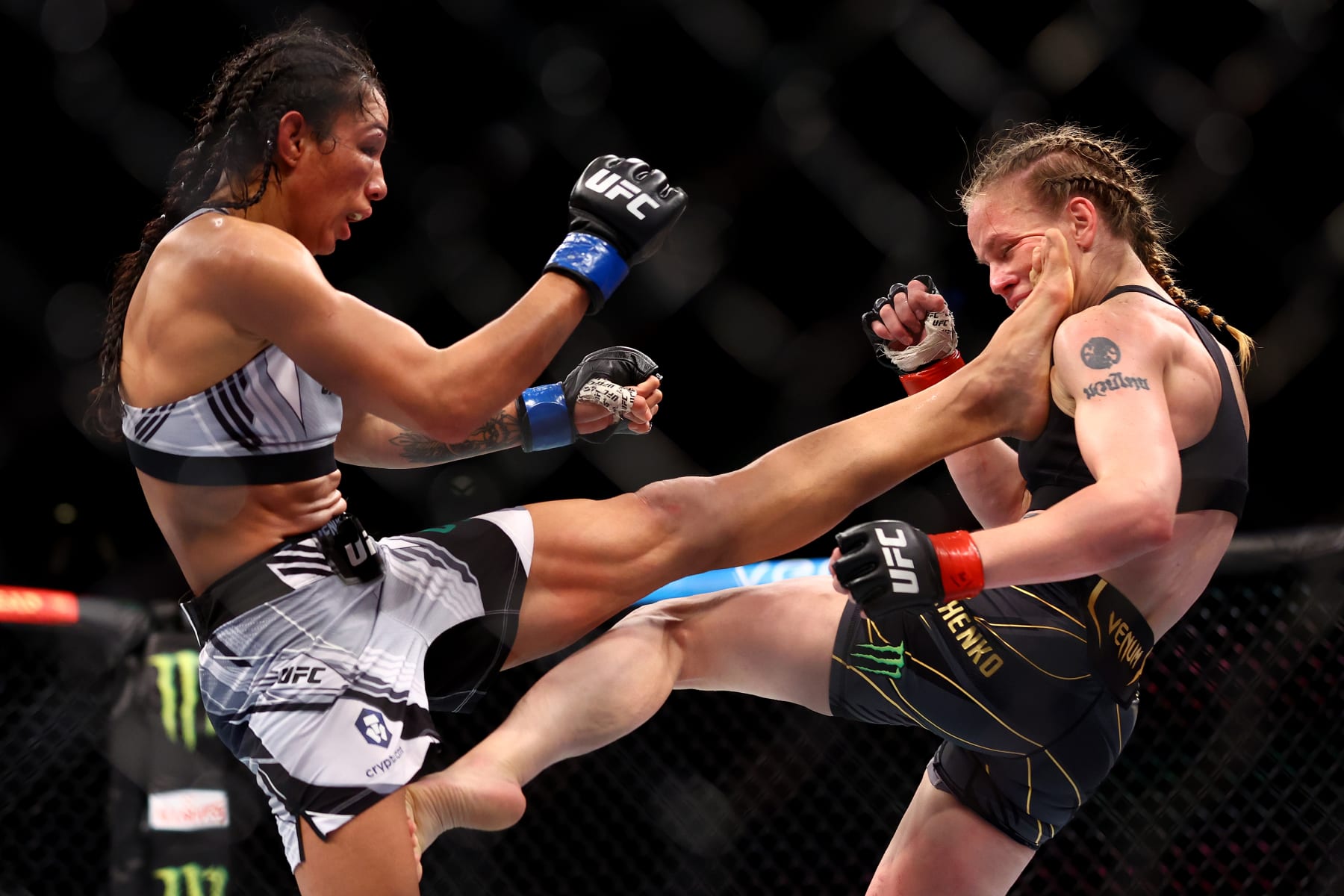 SINGAPORE, SINGAPORE - JUNE 12: Taila Santos (L) of Brazil kicks Valentina Shevchenko of Kyrgyzstan in their flyweight title bout during UFC 275 at Singapore Indoor Stadium on June 12, 2022 in Singapore. (Photo by Yong Teck Lim/Getty Images)