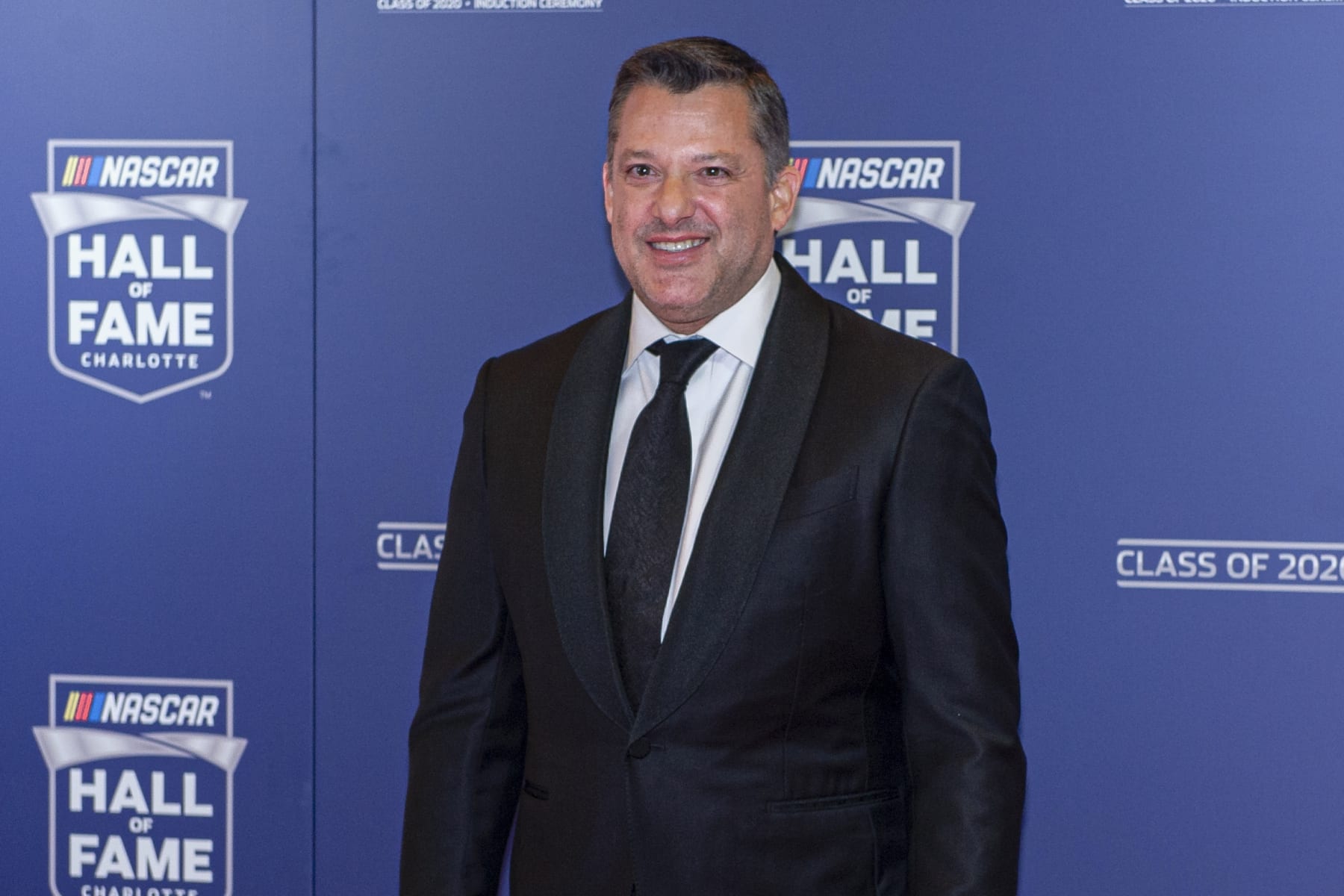 FILE - NASCAR Hall of Fame inductee Tony Stewart poses for pictures prior to the induction ceremony in Charlotte, N.C., in this Friday, Jan. 31, 2020, file photo. Tony Stewart wants to set the record straight about two misconstrued recent business decisions. Fans have been critical of Stewart since the Truck Series was dropped from Eldora Speedway and because he didn't sign Kyle Larson to his NASCAR team. Stewart is adamant that he tried to sign Larson but couldn't get partner approval on the driver suspended for using a racial slur. And he insists he dropped NASCAR after he felt slighted that Bristol Motor Speedway was given a Cup race on dirt. (AP Photo/Mike McCarn, File)