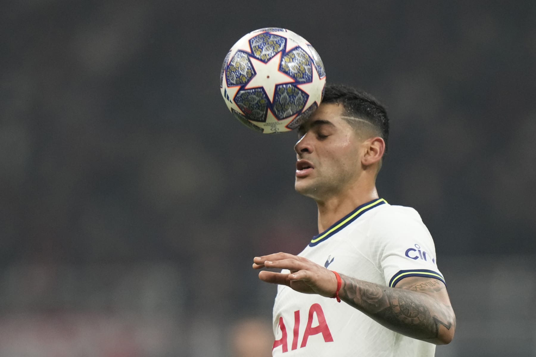 Tottenham's Cristian Romero heads the ball during the Champions League, round of 16, first leg soccer match between AC Milan and Tottenham Hotspur at the San Siro stadium in Milan , Italy, Tuesday, Feb. 14, 2023. (AP Photo/Luca Bruno)