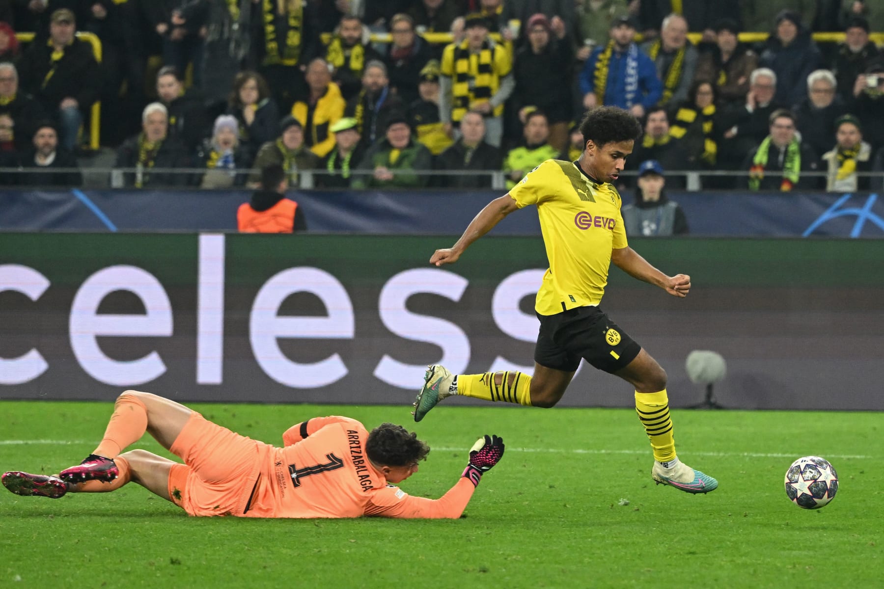 Dortmund's German forward Karim Adeyemi (R) goes past Chelsea's Spanish goalkeeper Kepa Arrizabalaga to score the opening goal during the UEFA Champions League, first-leg, round of 16 football match BVB Borussia Dortmund vs Chelsea FC, in Dortmund, western Germany, on February 15, 2023. (Photo by INA FASSBENDER / AFP) (Photo by INA FASSBENDER/AFP via Getty Images)