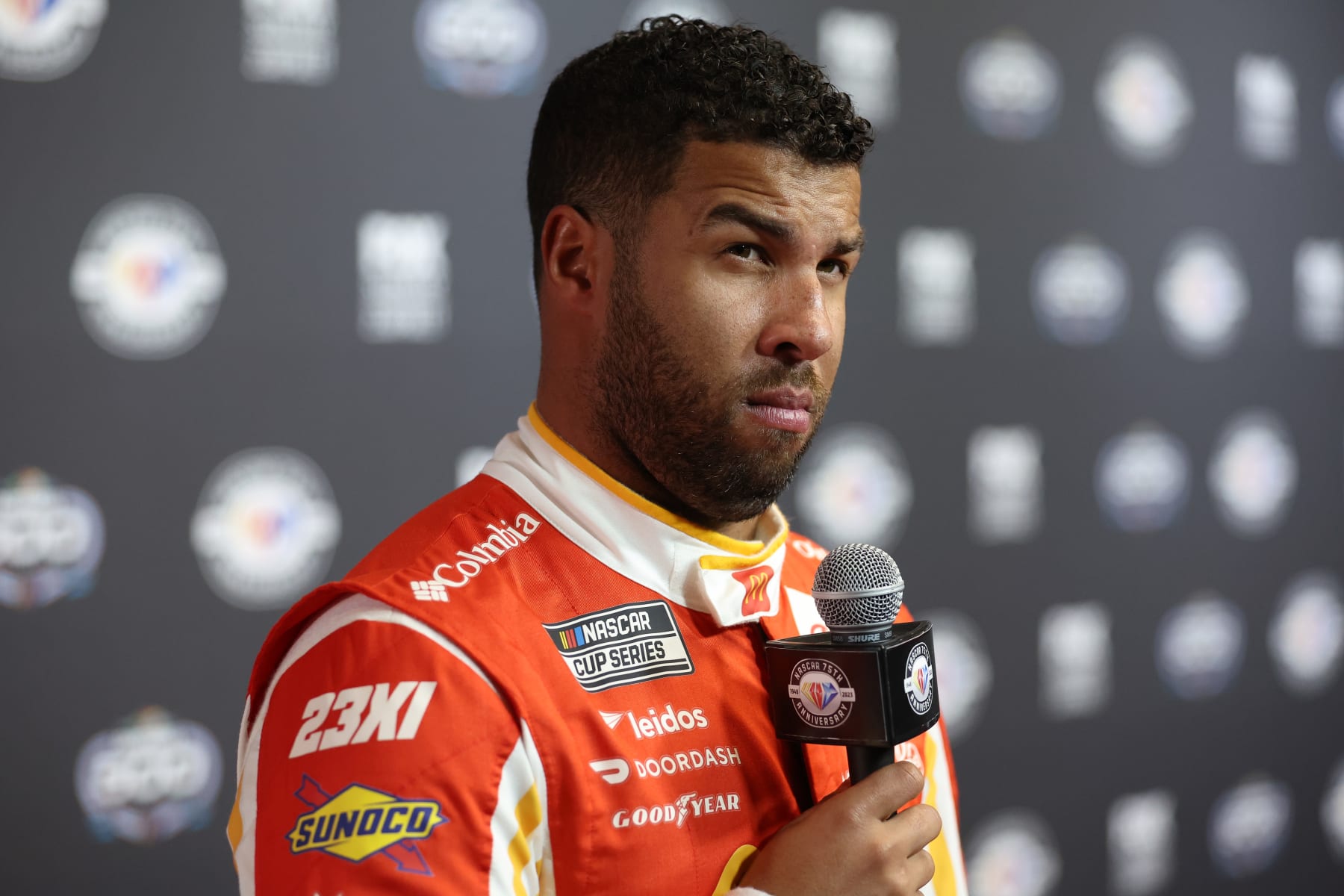 DAYTONA BEACH, FLORIDA - FEBRUARY 15: Bubba Wallace, driver of the #23 McDonald's Toyota, speaks to the media during the NASCAR Cup Series 65th Annual Daytona 500 Media Day at Daytona International Speedway on February 15, 2023 in Daytona Beach, Florida. (Photo by James Gilbert/Getty Images)