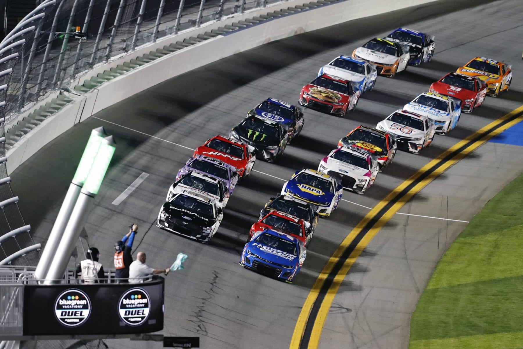 Kyle Larson, front right, and Aric Almirola, front left, take the green flag as they lead the field to start the second of two qualifying auto races for the NASCAR Daytona 500 at Daytona International Speedway, Thursday, Feb. 16, 2023, in Daytona Beach, Fla. (AP Photo/David Graham)