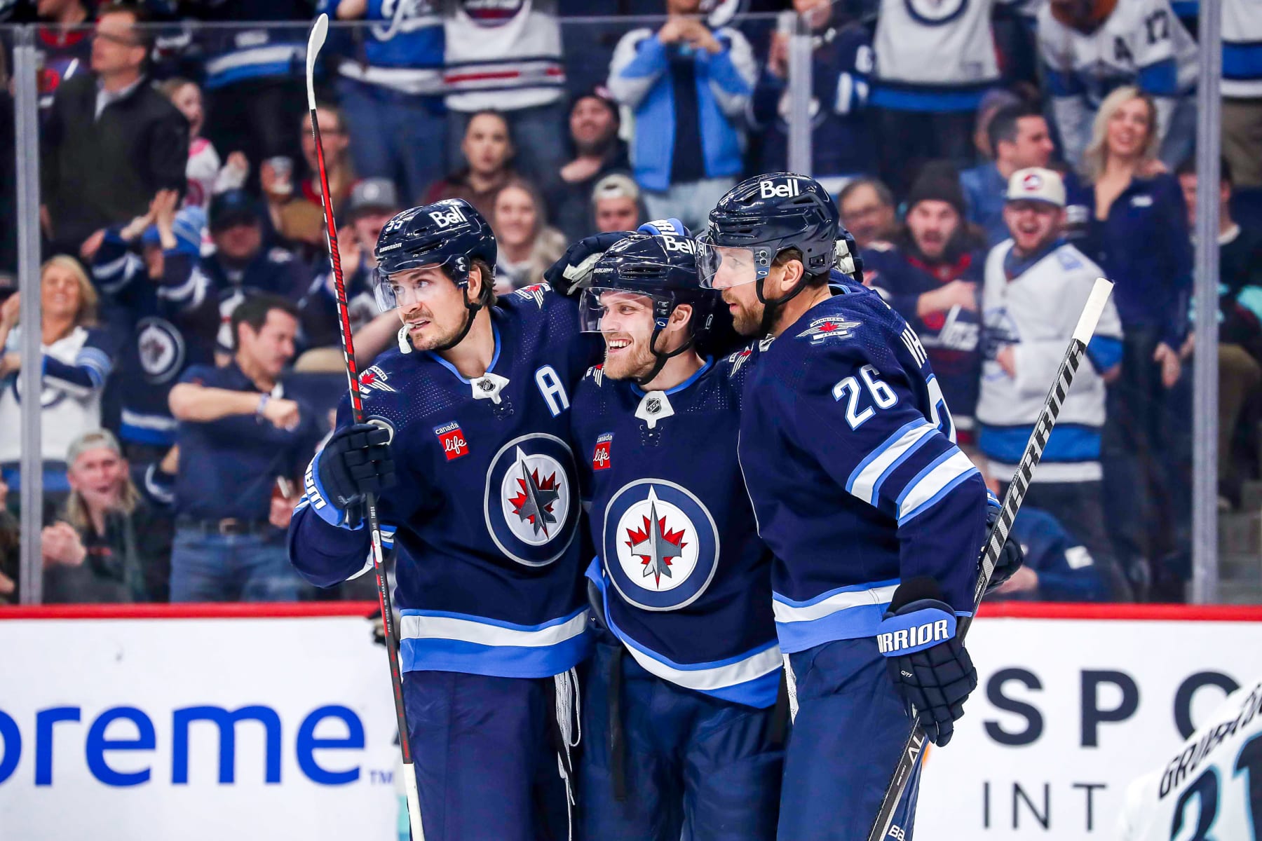WINNIPEG, CANADA - FEBRUARY 14: Mark Scheifele #55, Nikolaj Ehlers #27 and Blake Wheeler #26 of the Winnipeg Jets celebrate a second period goal against the Seattle Kraken at the Canada Life Centre on February 14, 2023 in Winnipeg, Manitoba, Canada. (Photo by Darcy Finley/NHLI via Getty Images) WINNIPEG, CANADA - FEBRUARY 14: Mark Scheifele #55, Nikolaj Ehlers #27 and Blake Wheeler #26 of the Winnipeg Jets celebrate a second period goal against the Seattle Kraken at the Canada Life Centre on February 14, 2023 in Winnipeg, Manitoba, Canada. (Photo by Darcy Finley/NHLI via Getty Images)
